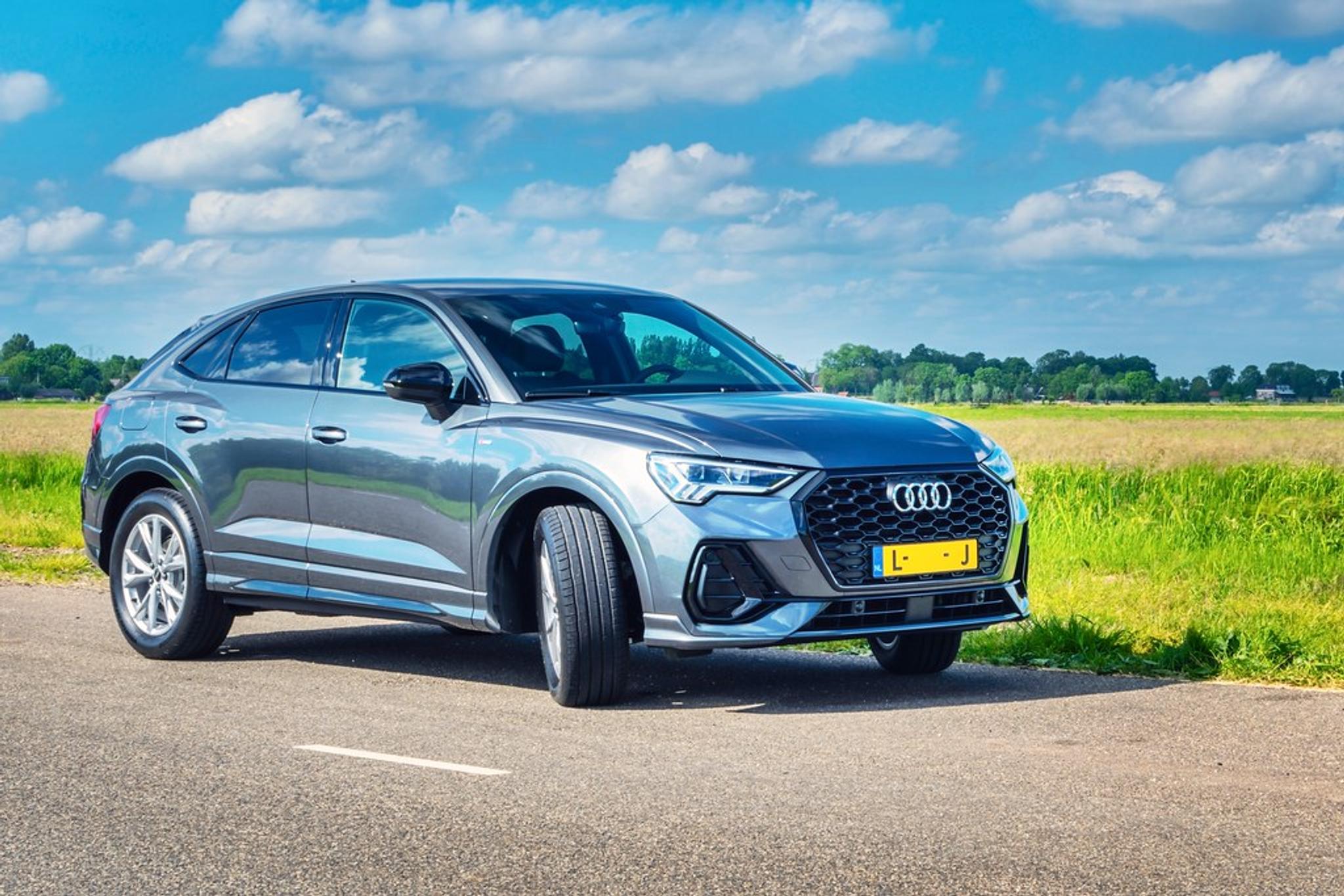 Grey Audi Q3 next to a field