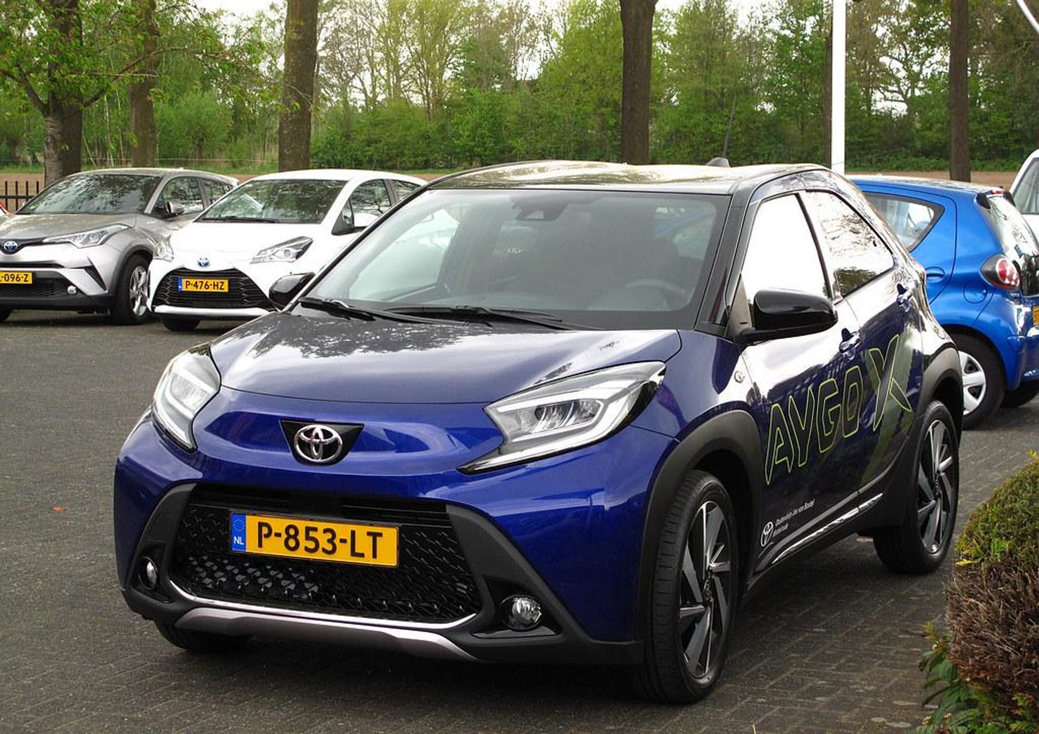Blue Toyota Aygo X in a parking lot
