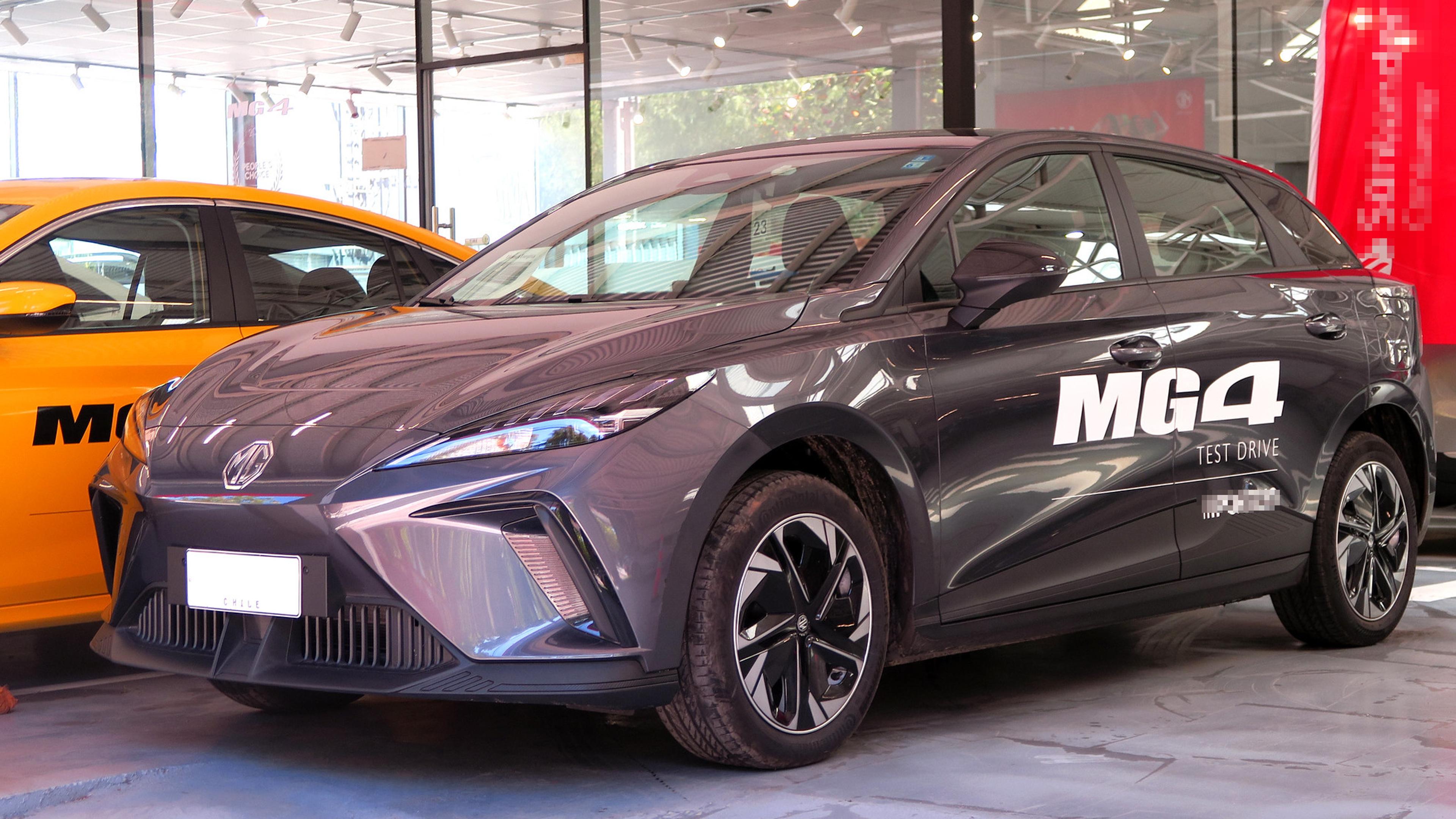 A dark grey MG4 EV in a showroom