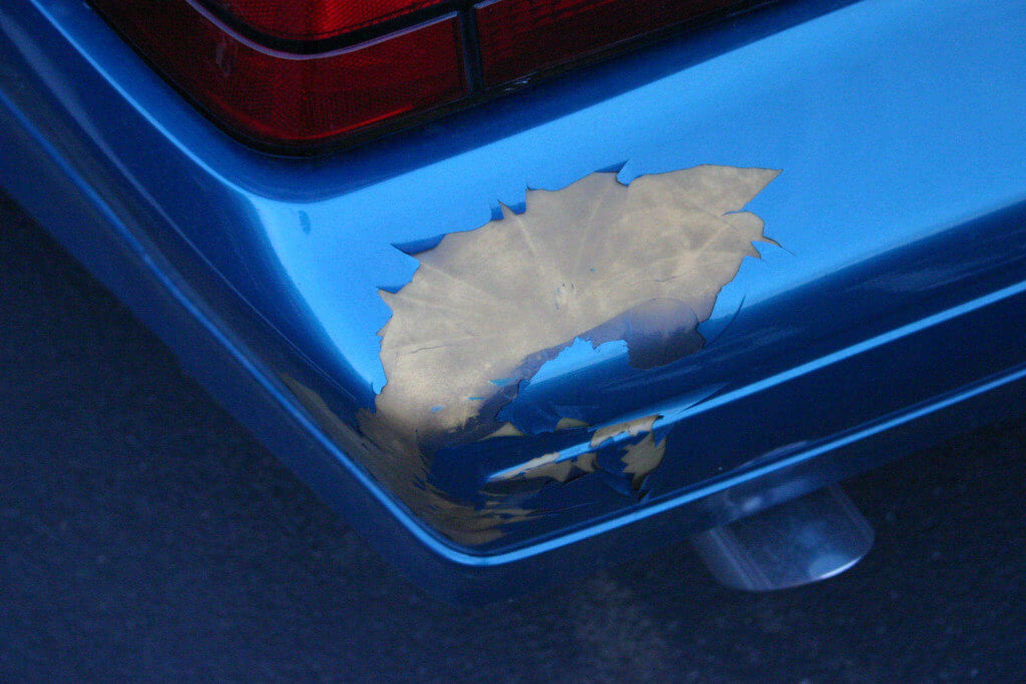 Blue car with peeled off paint protection film