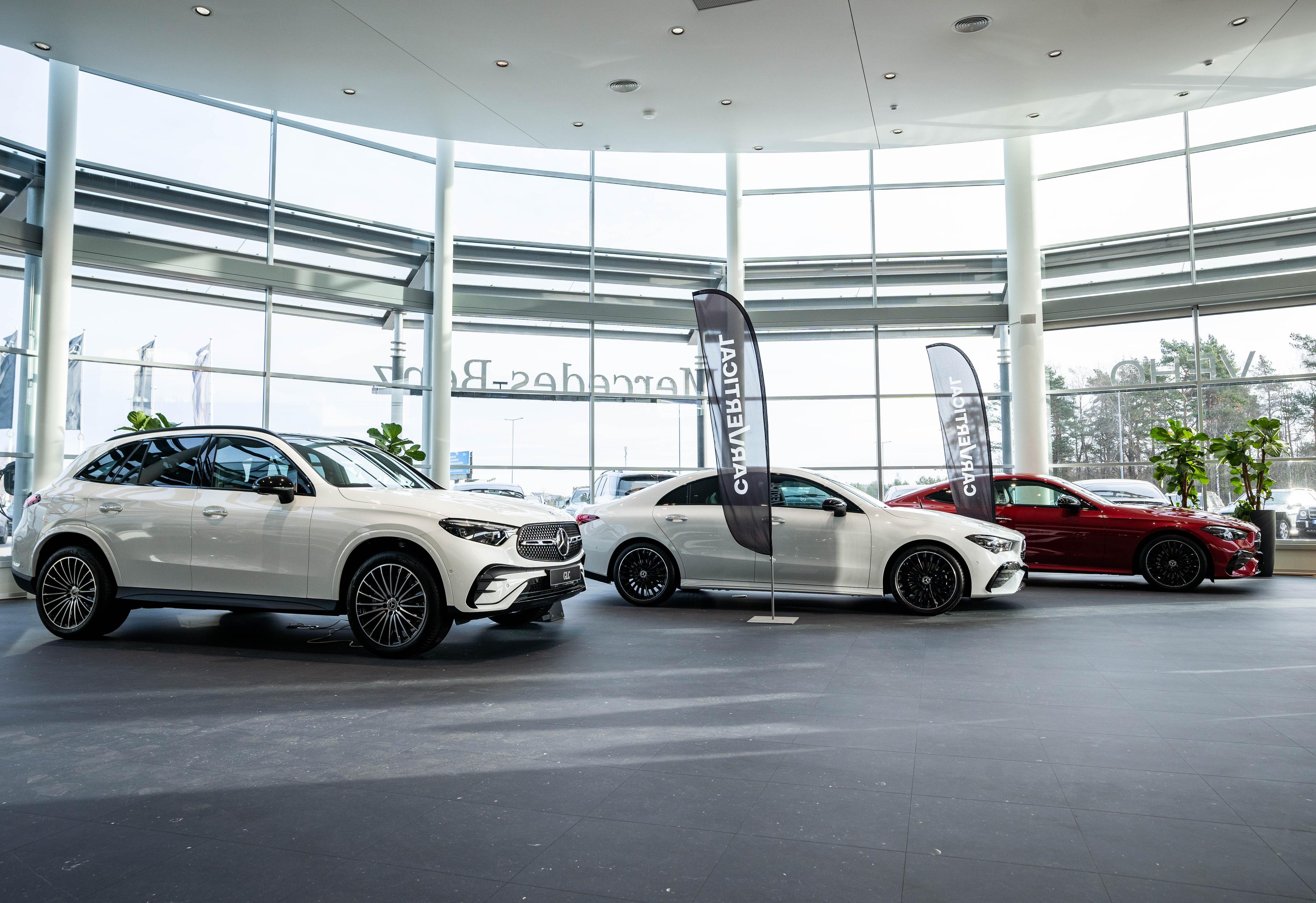 Three cars at a dealership