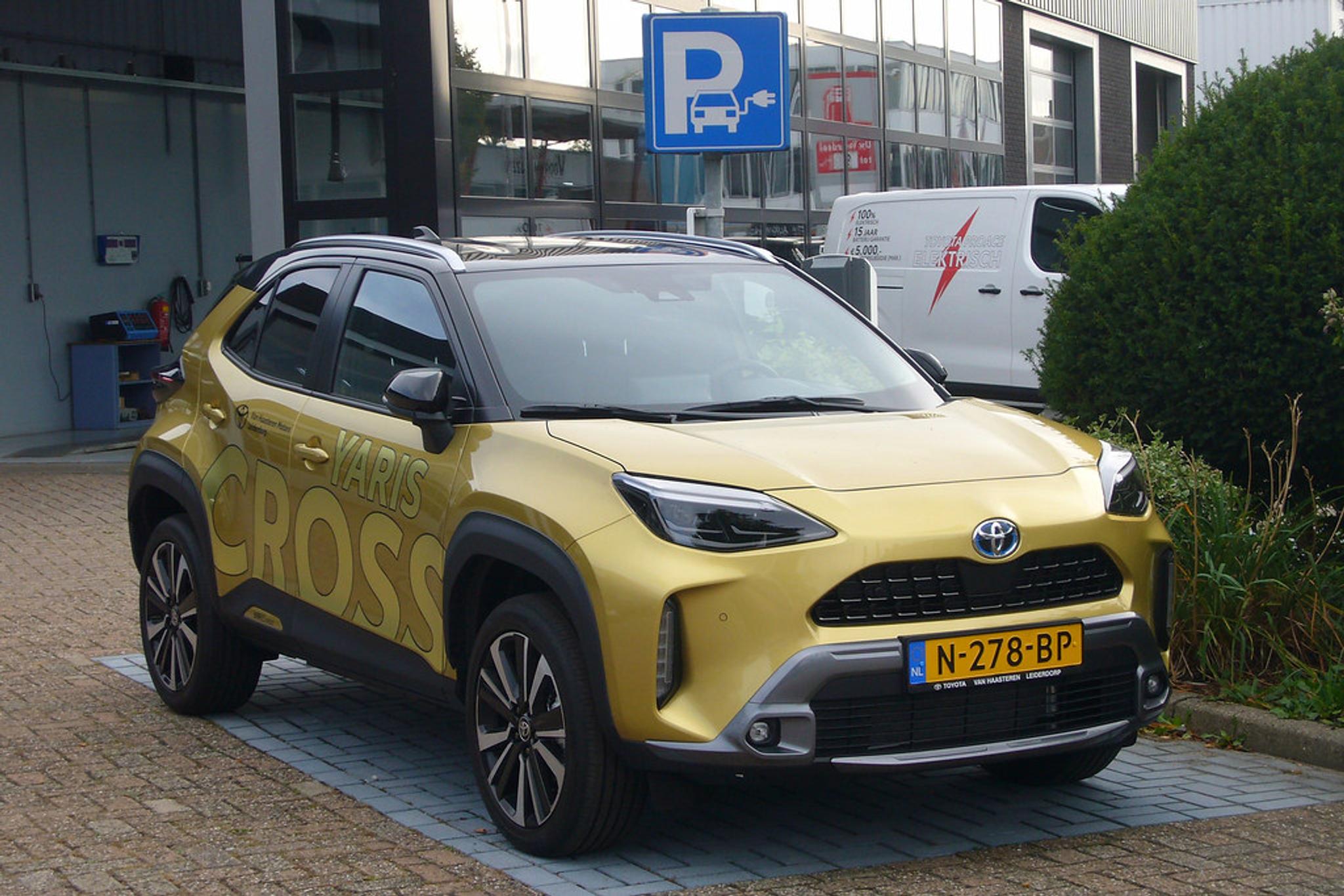 A golden Toyota Yaris Cross in a hybrid car parking spot