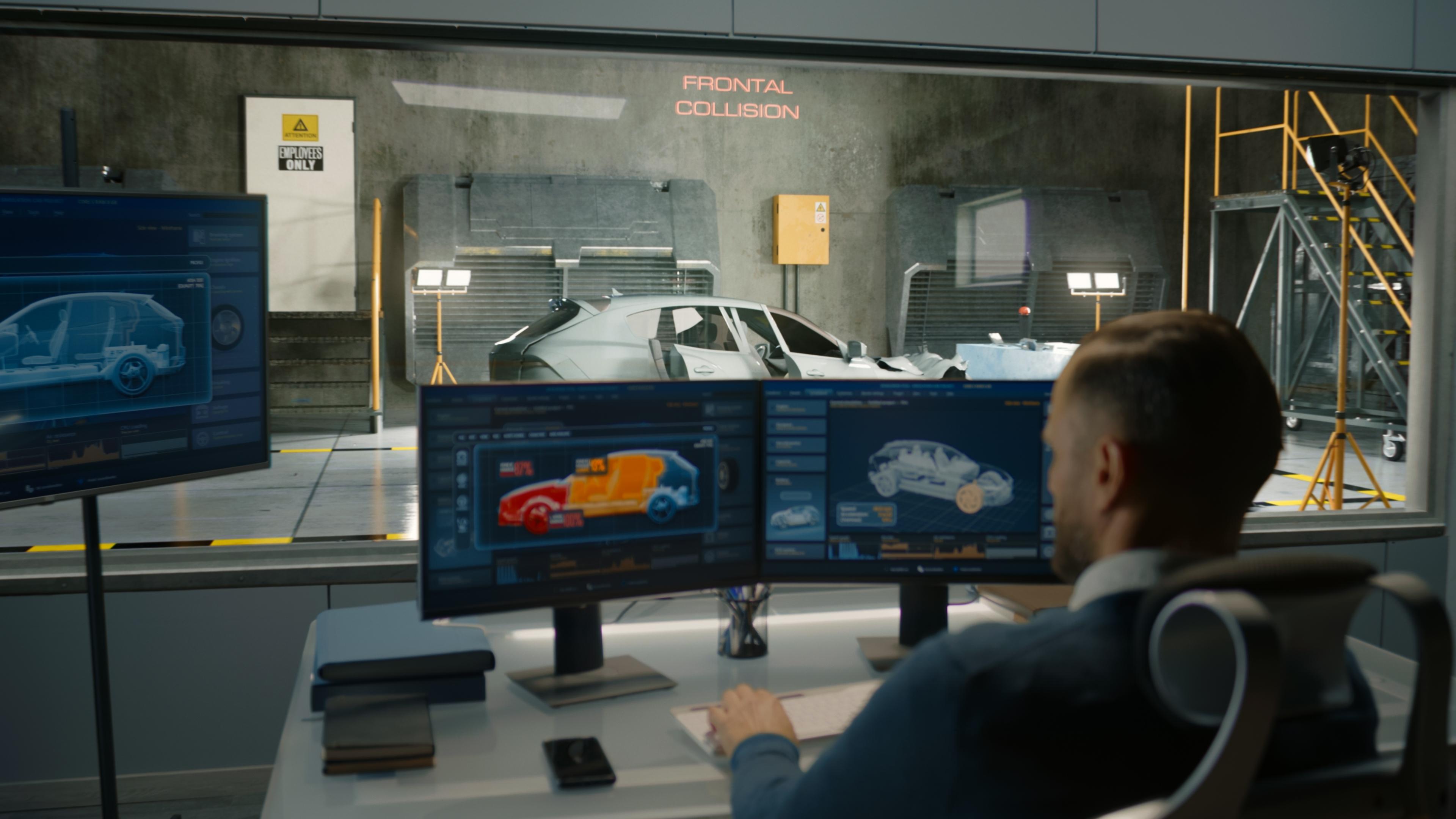 A man in a lab uses a car crash test system to simulate a traffic accident