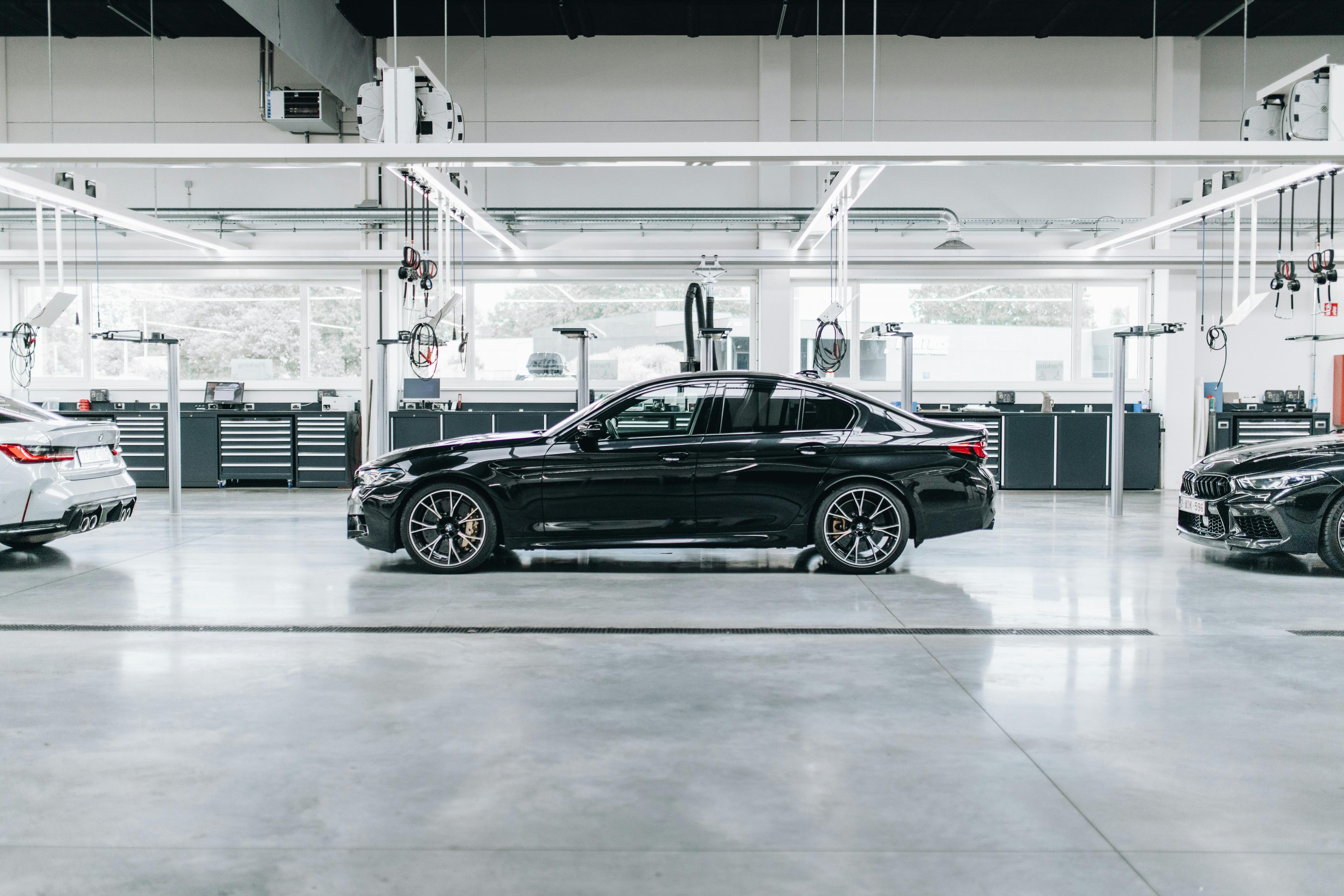 Black sedan parked at a parking lot