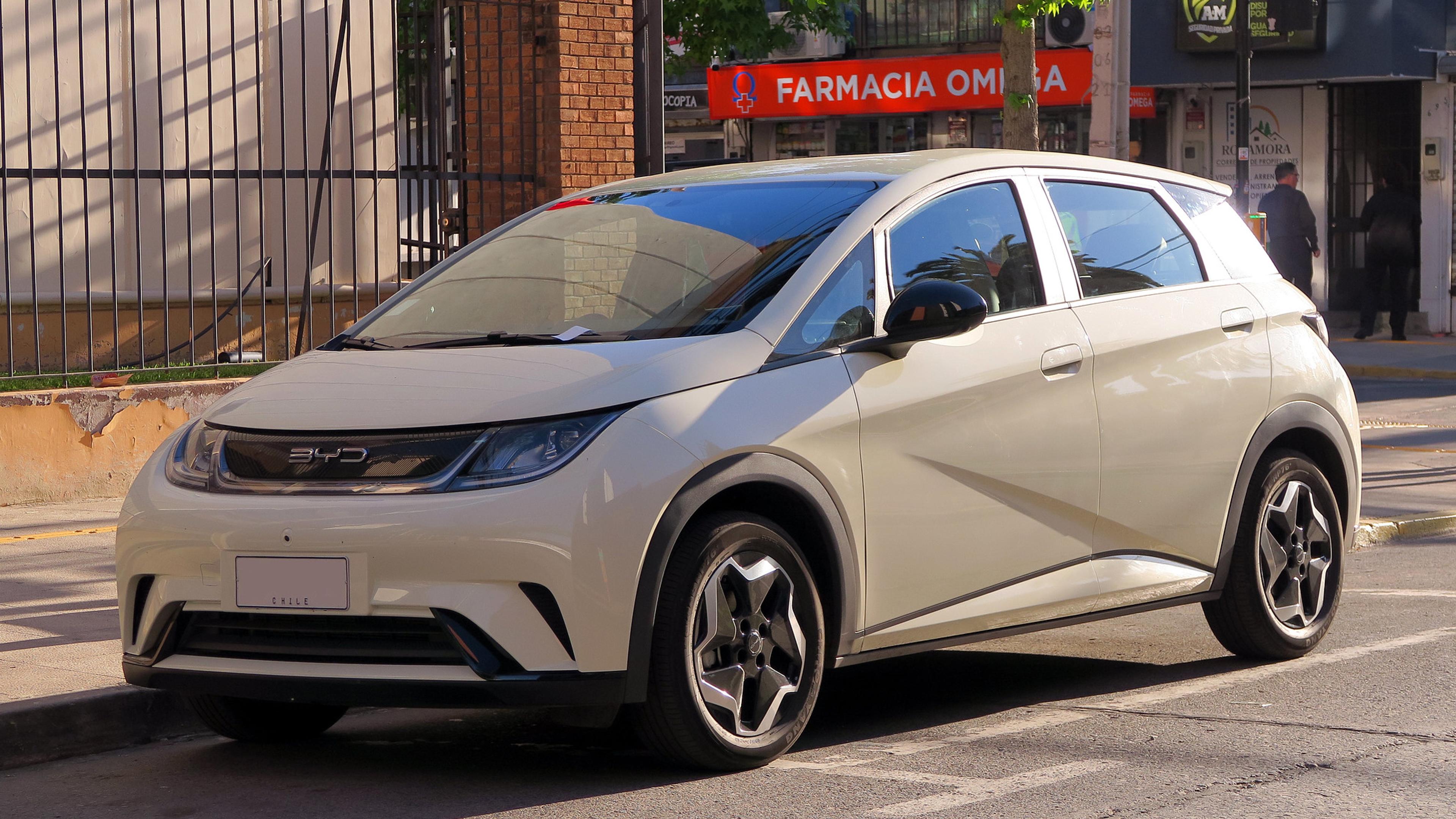 A white BYD Dolphin parked in the sun