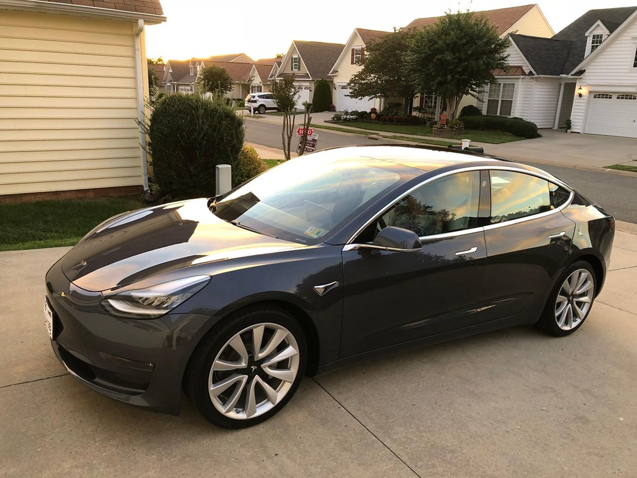 Black Tesla Model 3 in the driveway