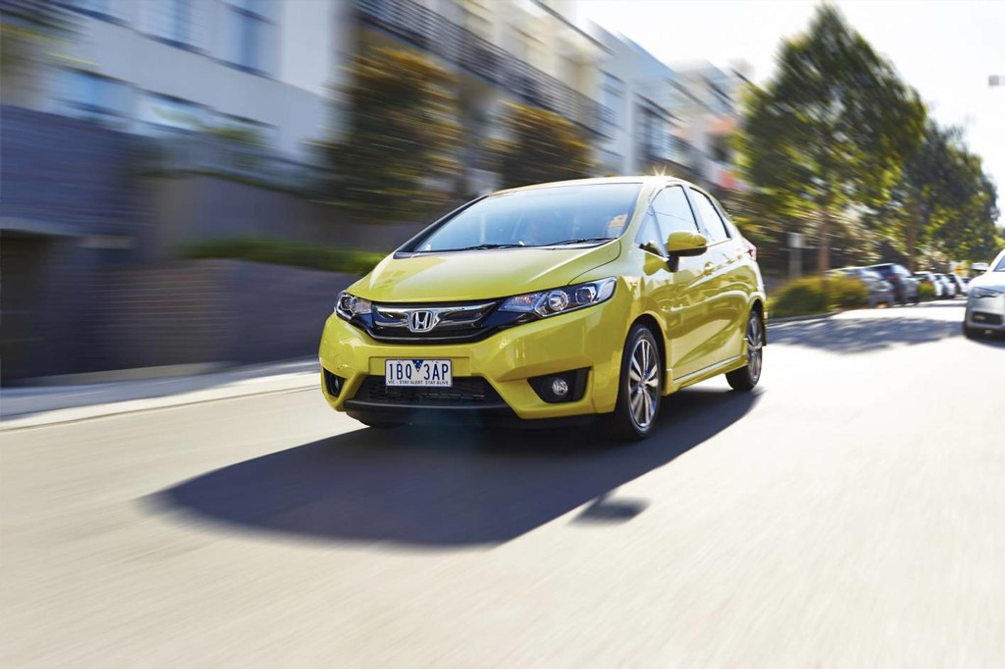 Yellow Honda Jazz on the move