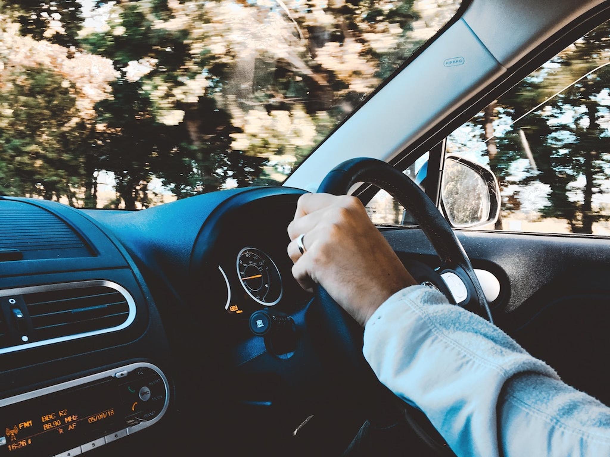 Man holding a steering wheel