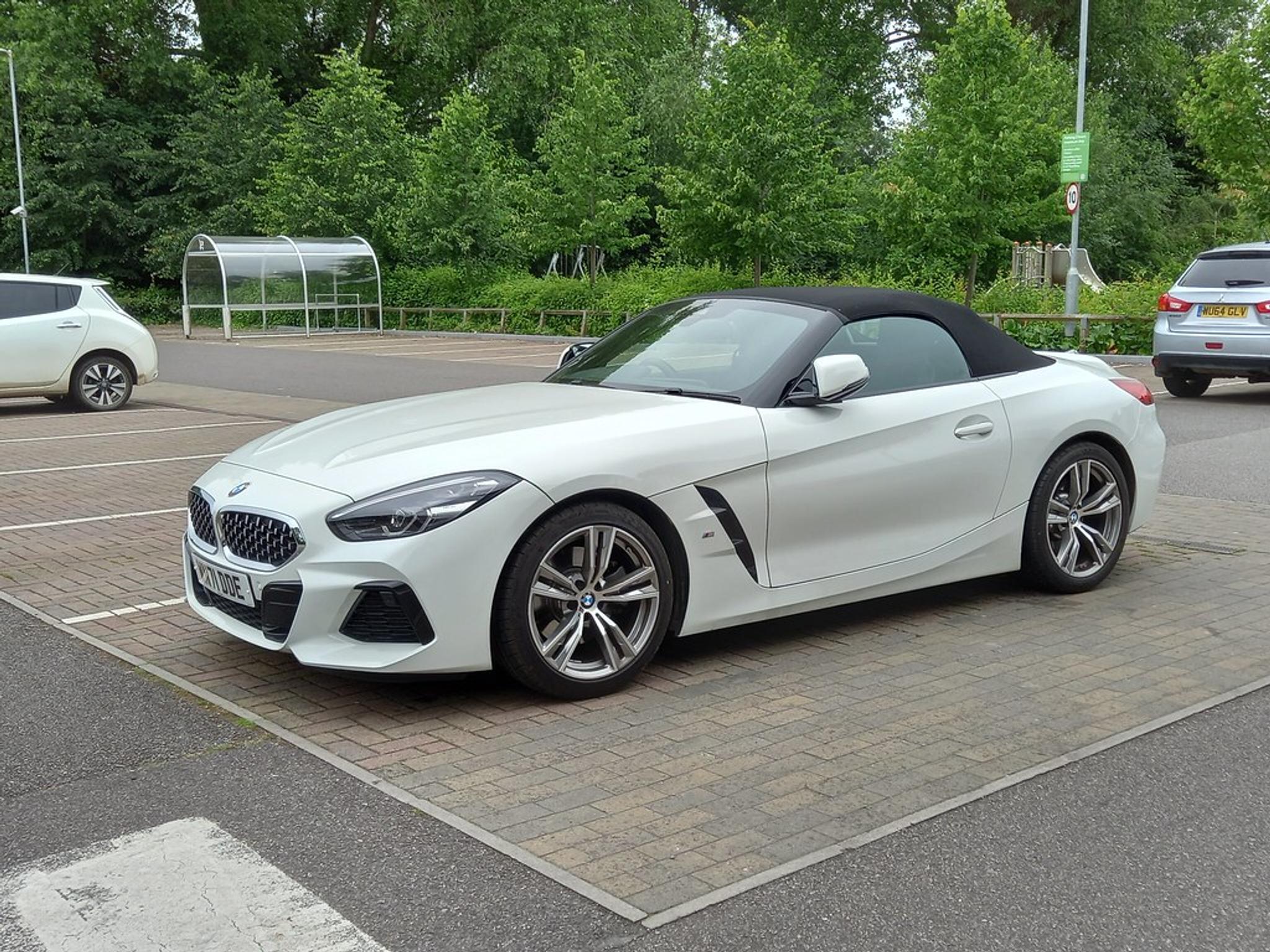 White BMW Z4 convertible in a parking lot