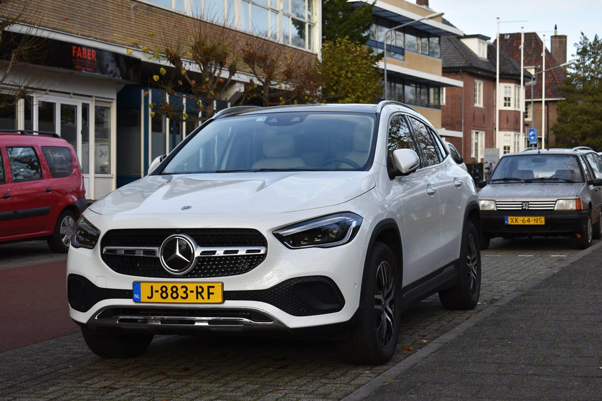 White Mercedes-Benz GLA on the side of the street