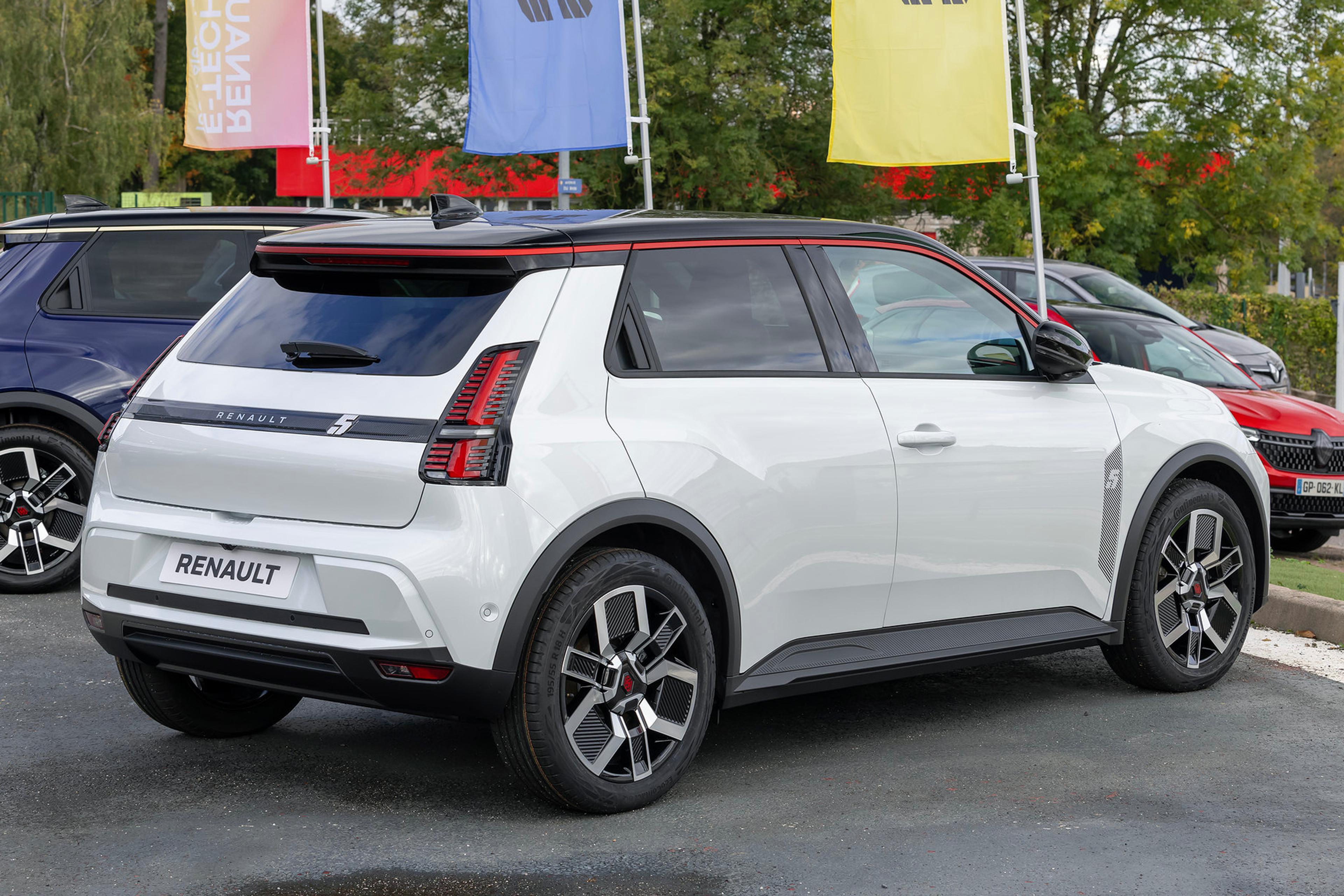 A white Renault 5 E-Tech in parking lot