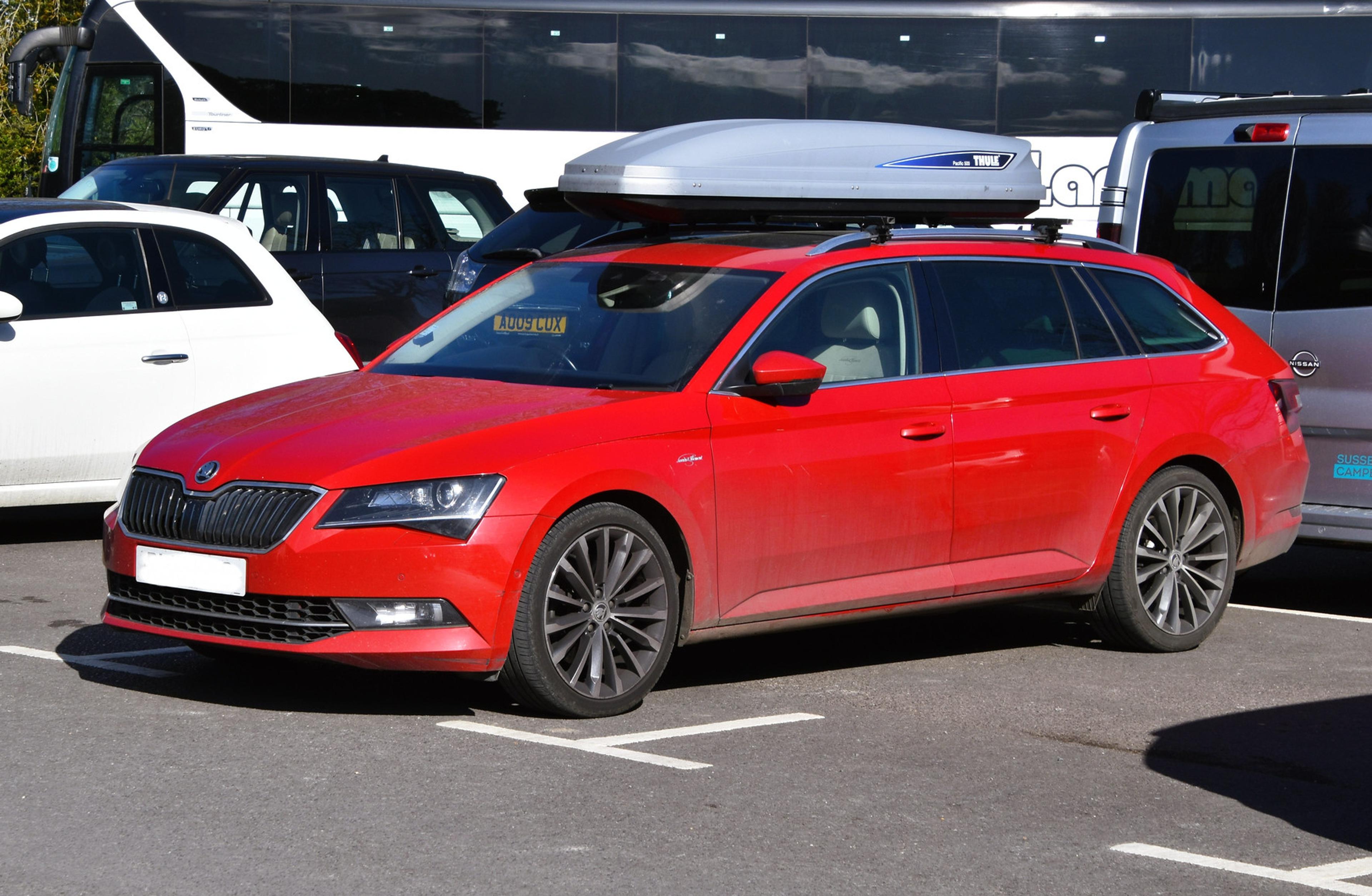 Red Škoda Superb Estate in a parking space  