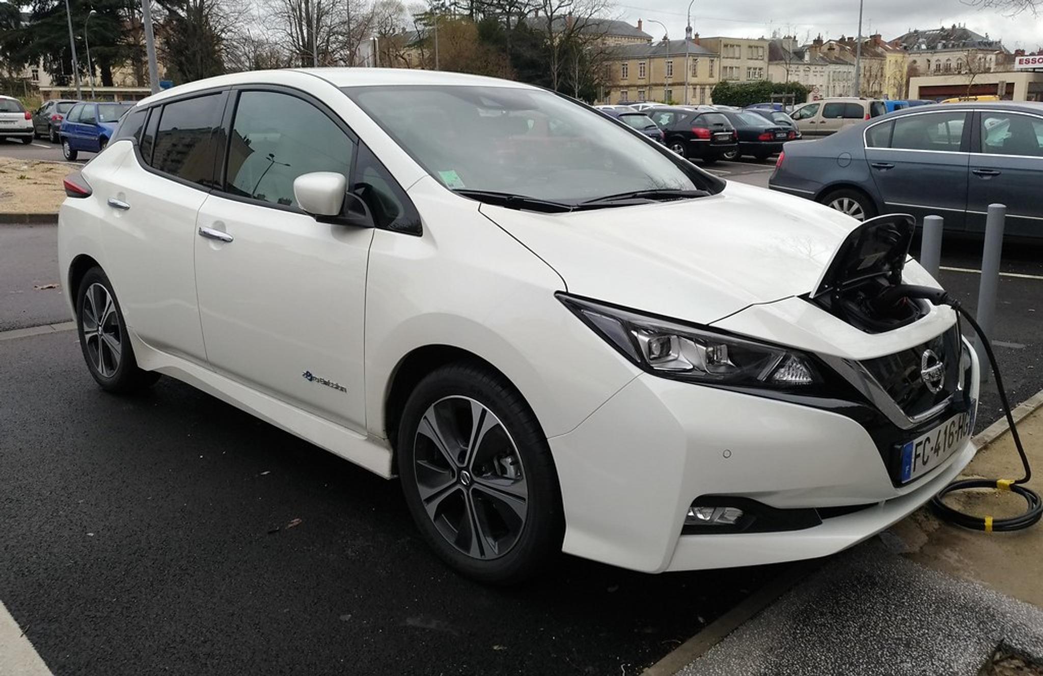 White Nissan Leaf in a public charging spot