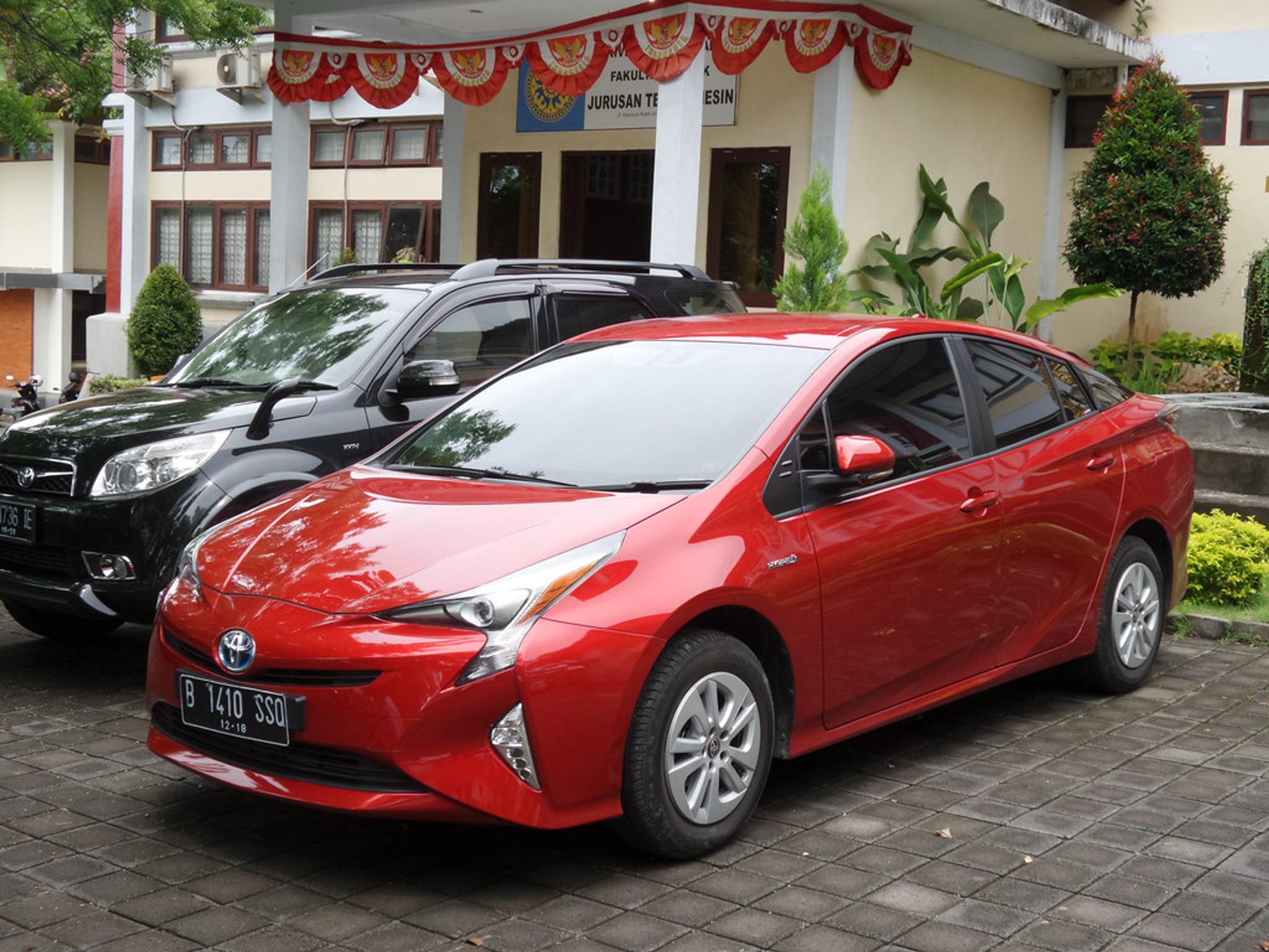 Red Toyota Prius with aero rims