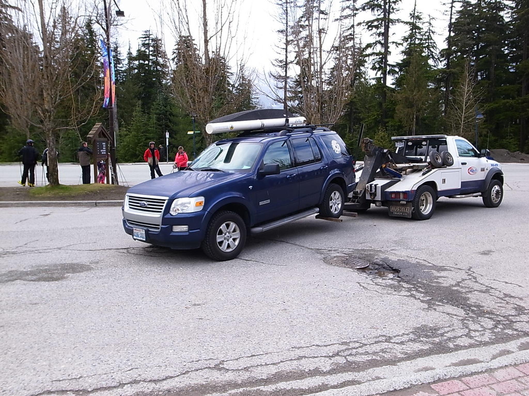 A blue car getting towed