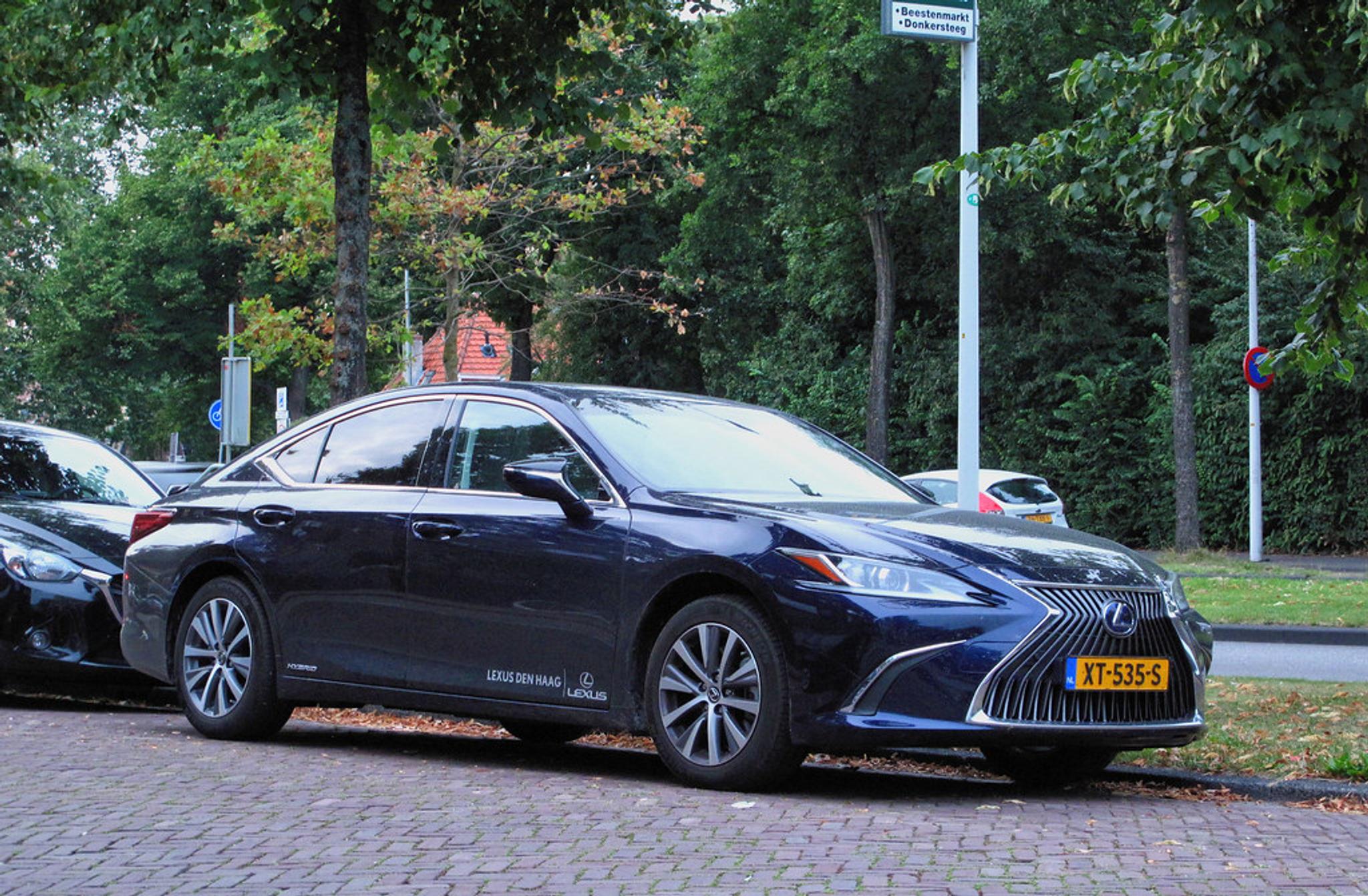 Blue Lexus ES hybrid on the side of the road