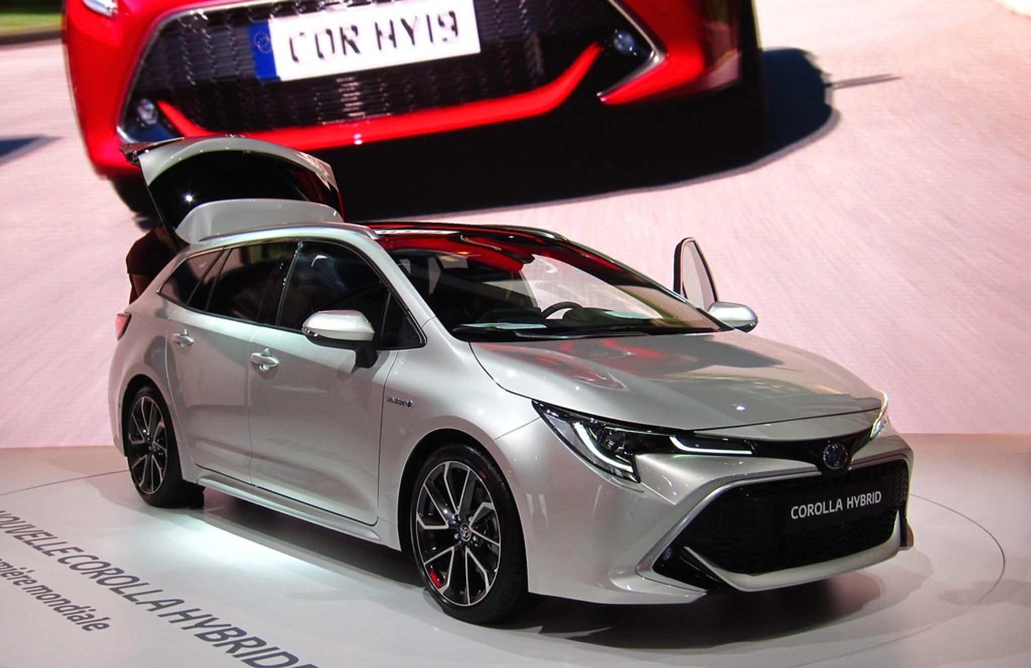 Silver Toyota Corolla Hybrid in a showroom