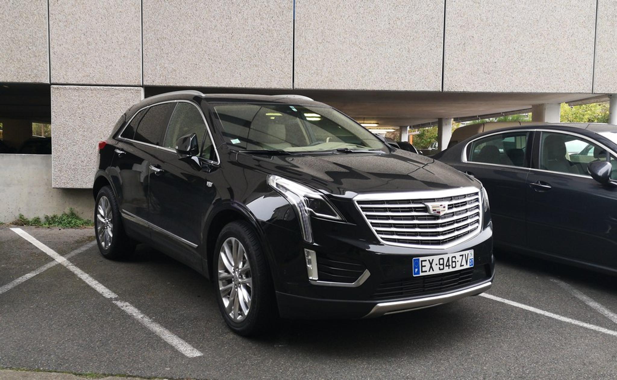Black Cadillac XT5 in a parking lot