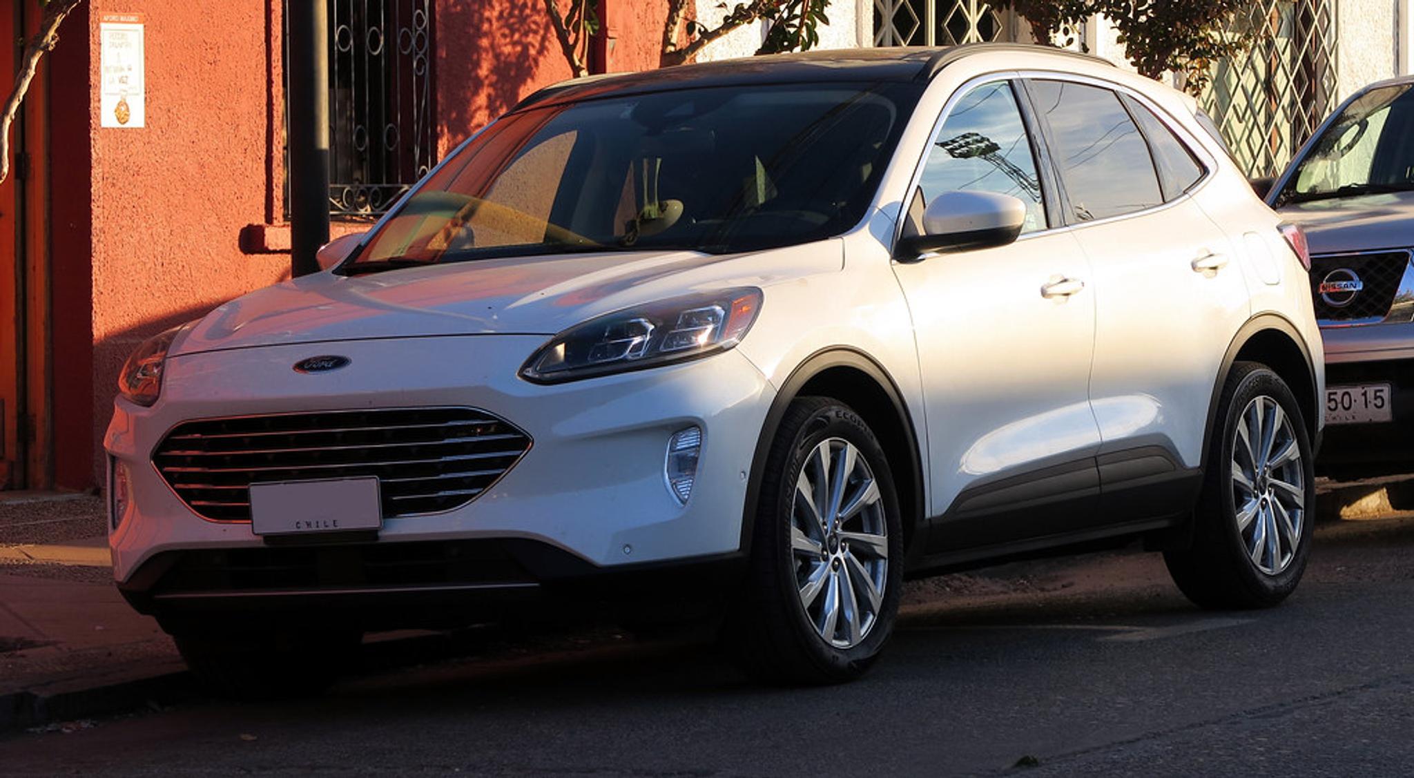 White Ford Escape parked by the curb