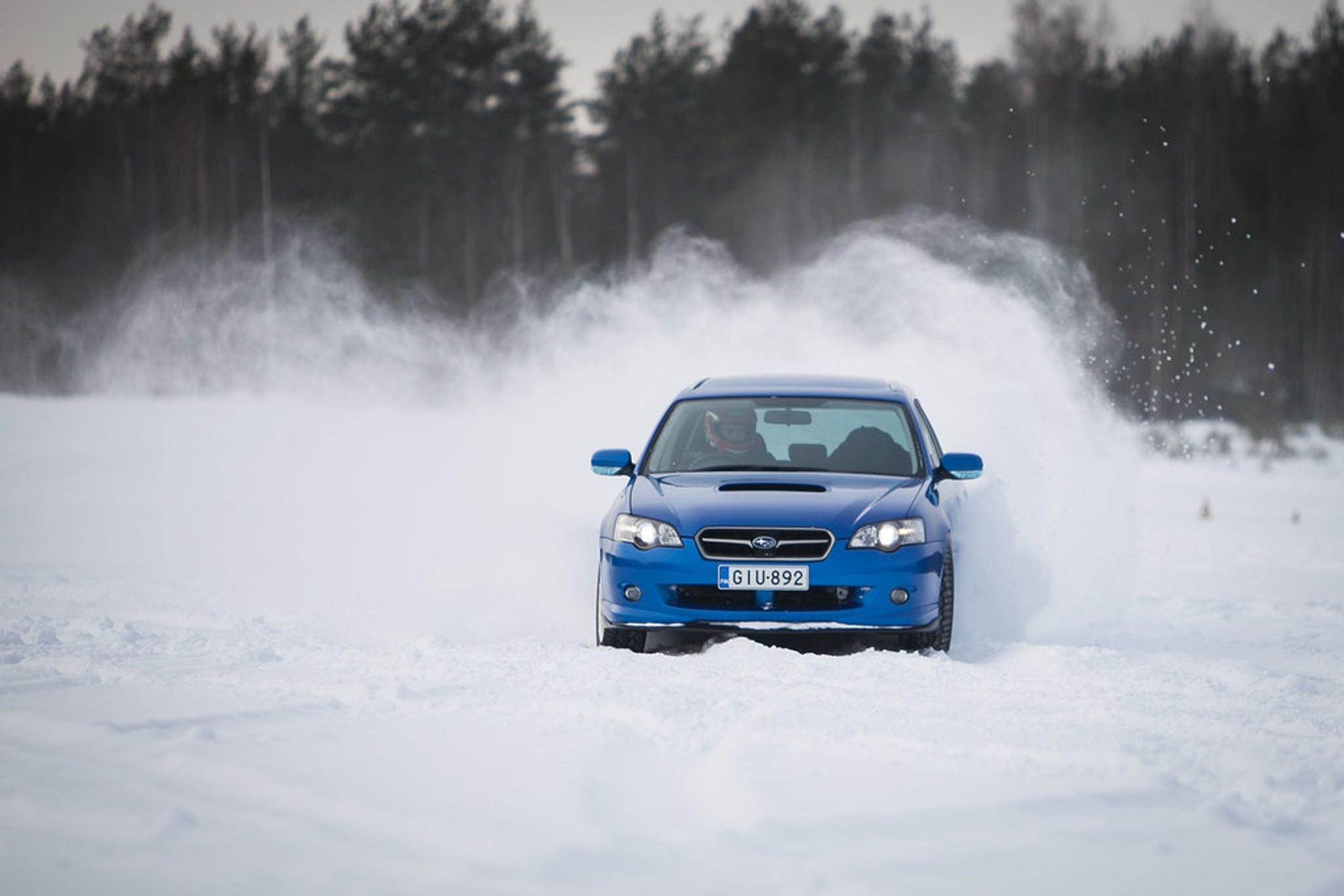 drifting in snow, blue subaru, driving in snow, slippery road,