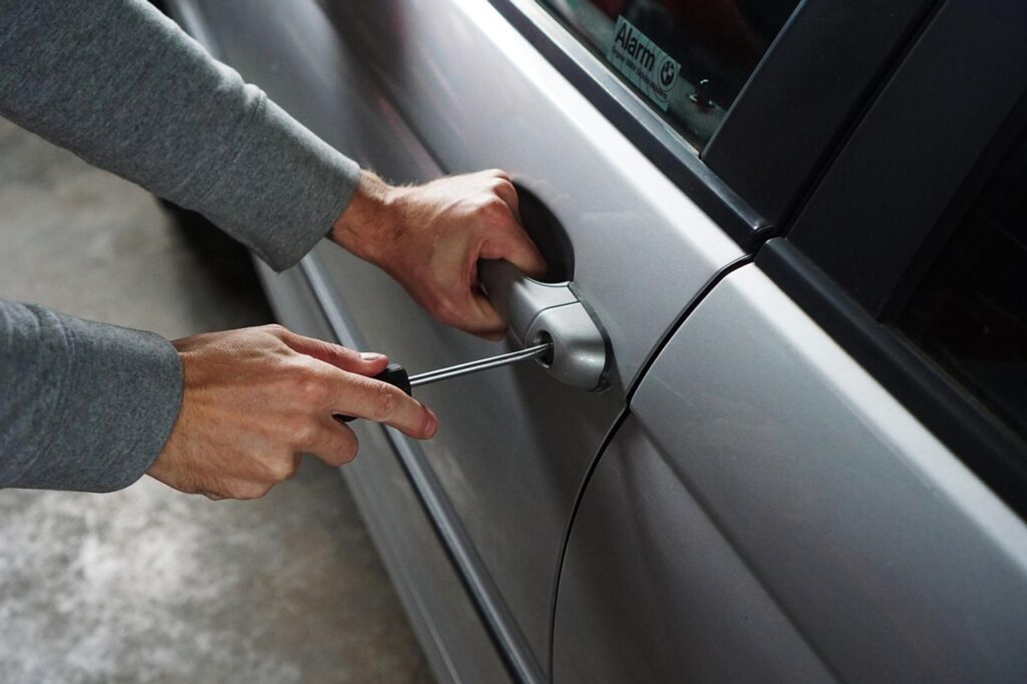 Car locksmith trying to open the doors