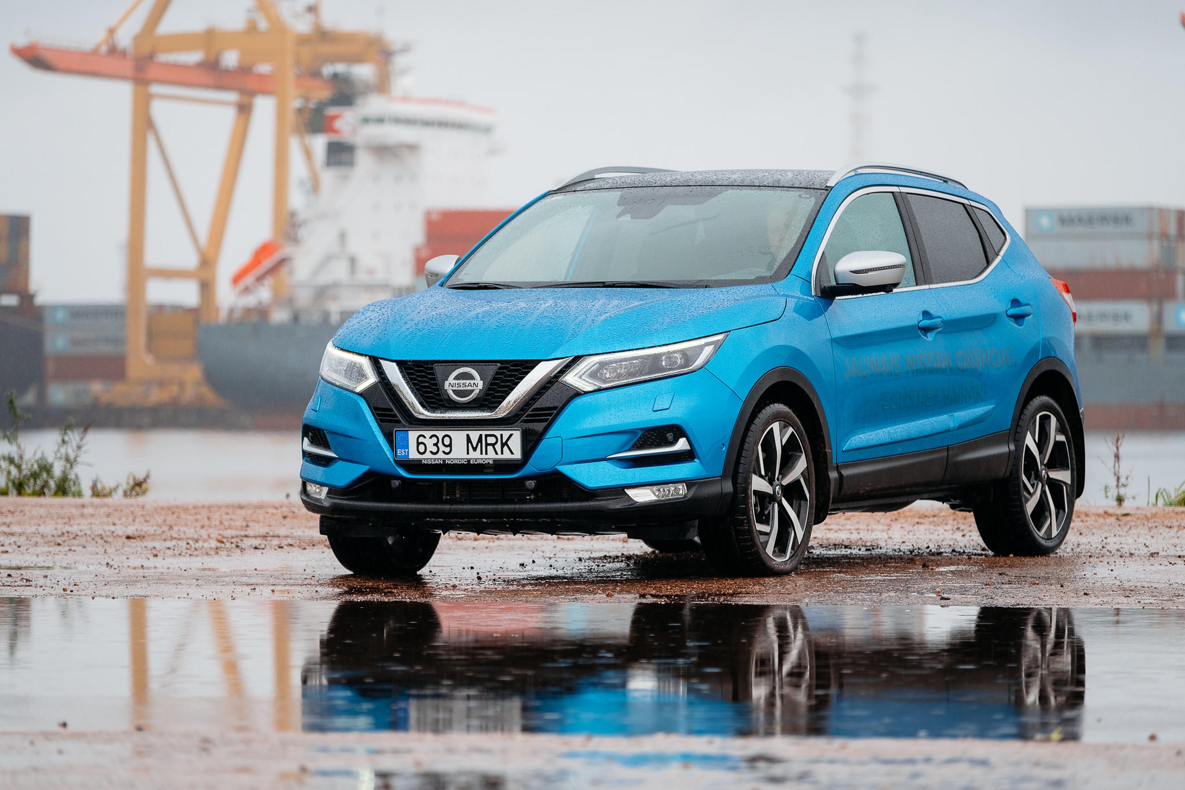 A blue Nissan Quashqai in the rain  
