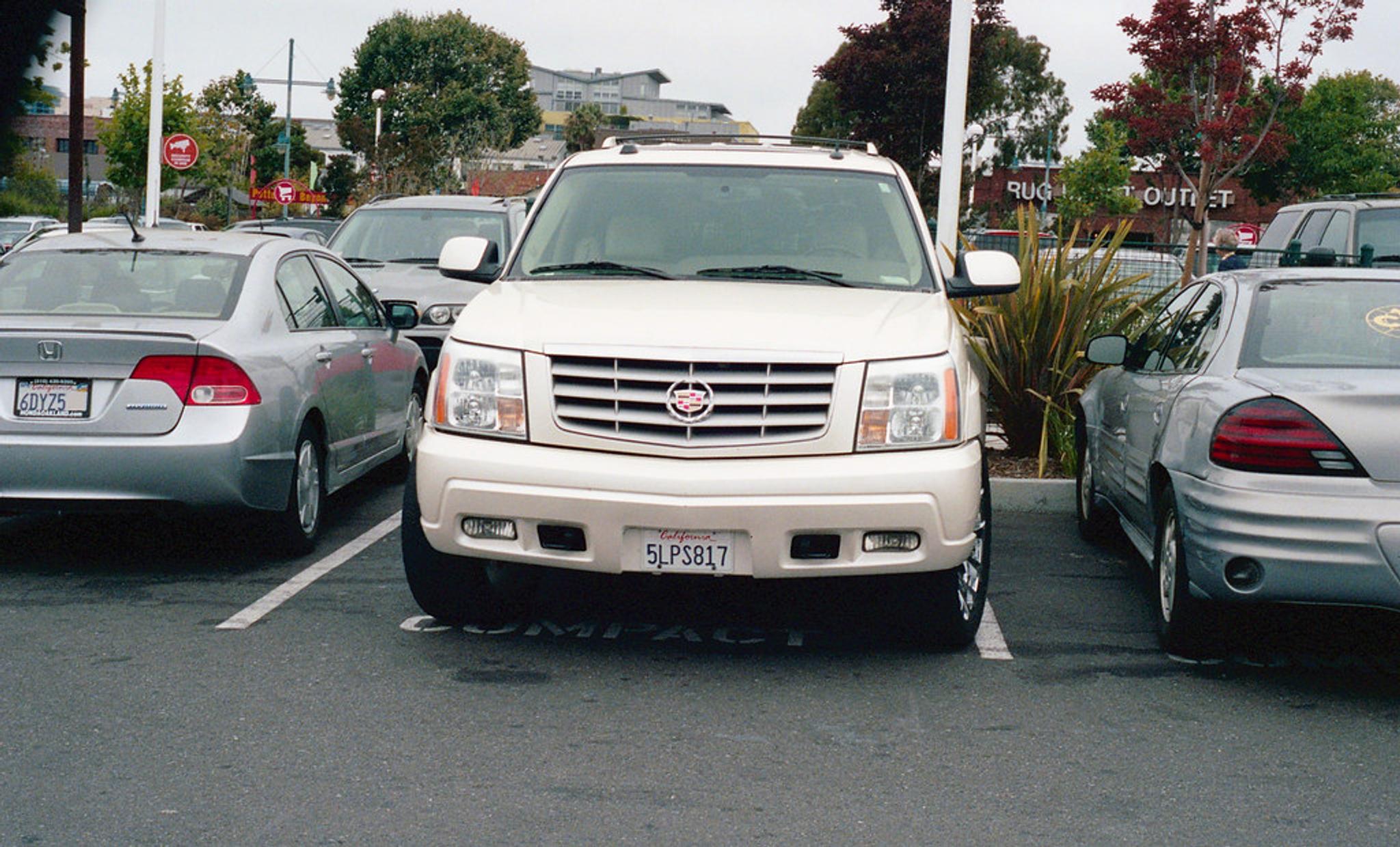 cadillac escalage, car in a parking lot, parked Cadillac, suv