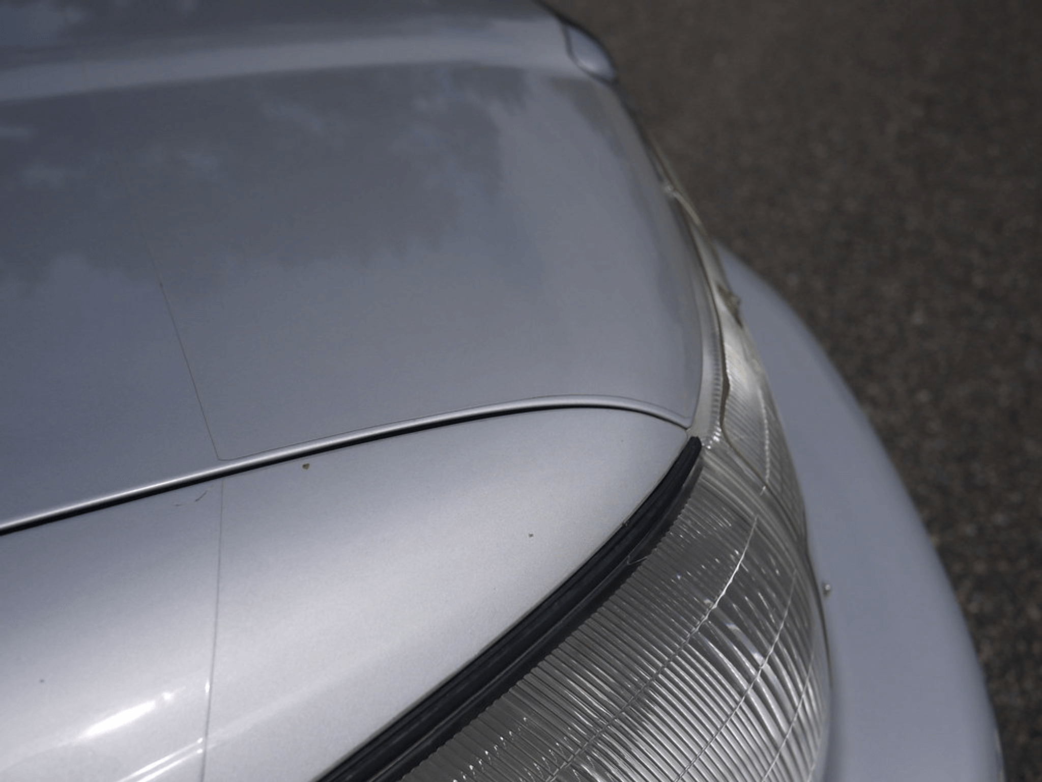 Old paint protection film on a grey car