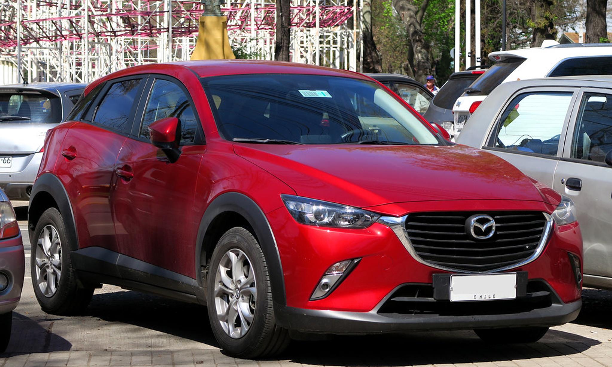Red Mazda CX-3 in a parking lot in a three quarter view