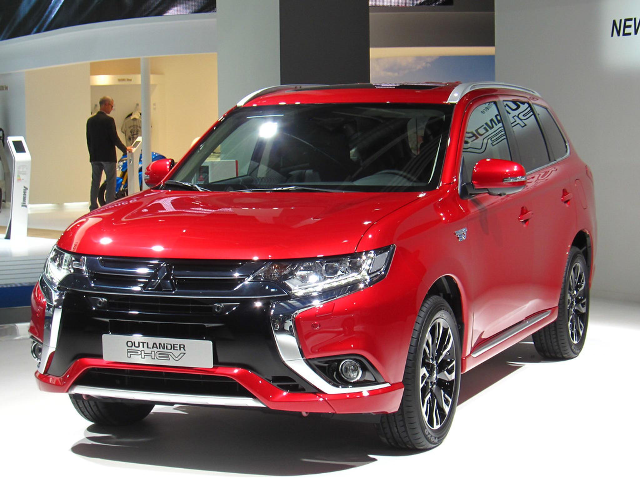Red Mitsubishi Outlander PHEV in a showroom