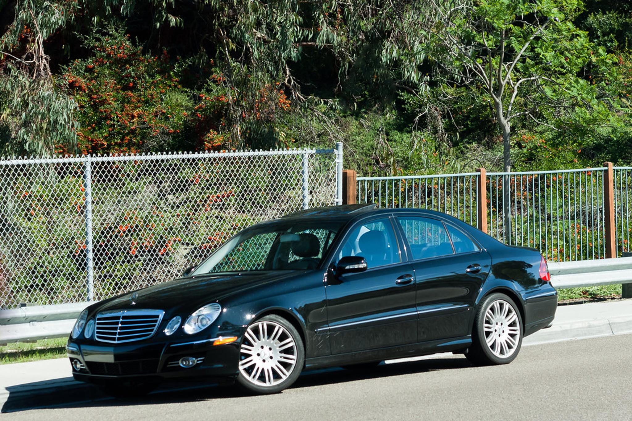 Black Mercedes Benz E Class W211 on the side of the road