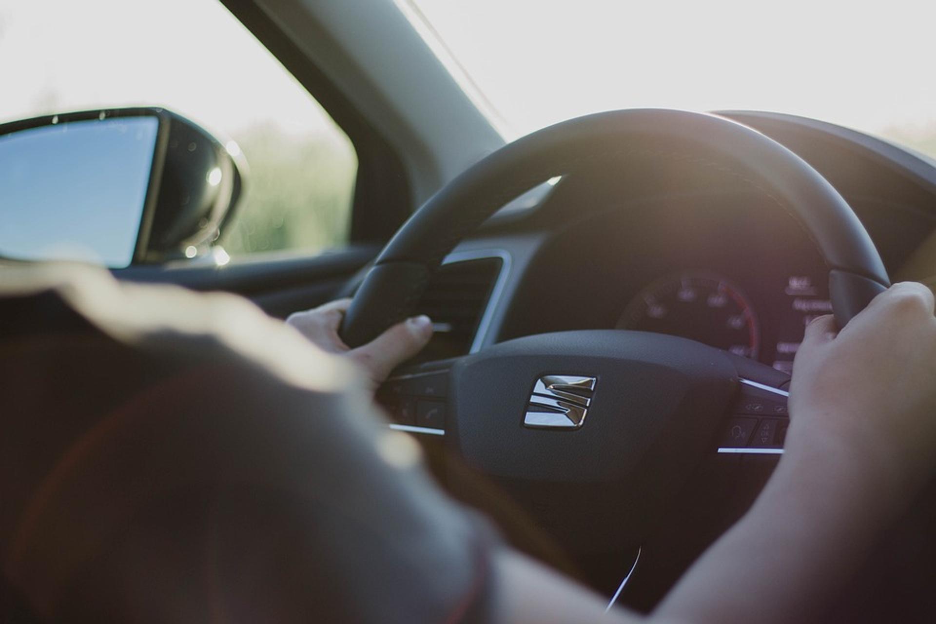 Person sitting henind Seat steering wheel