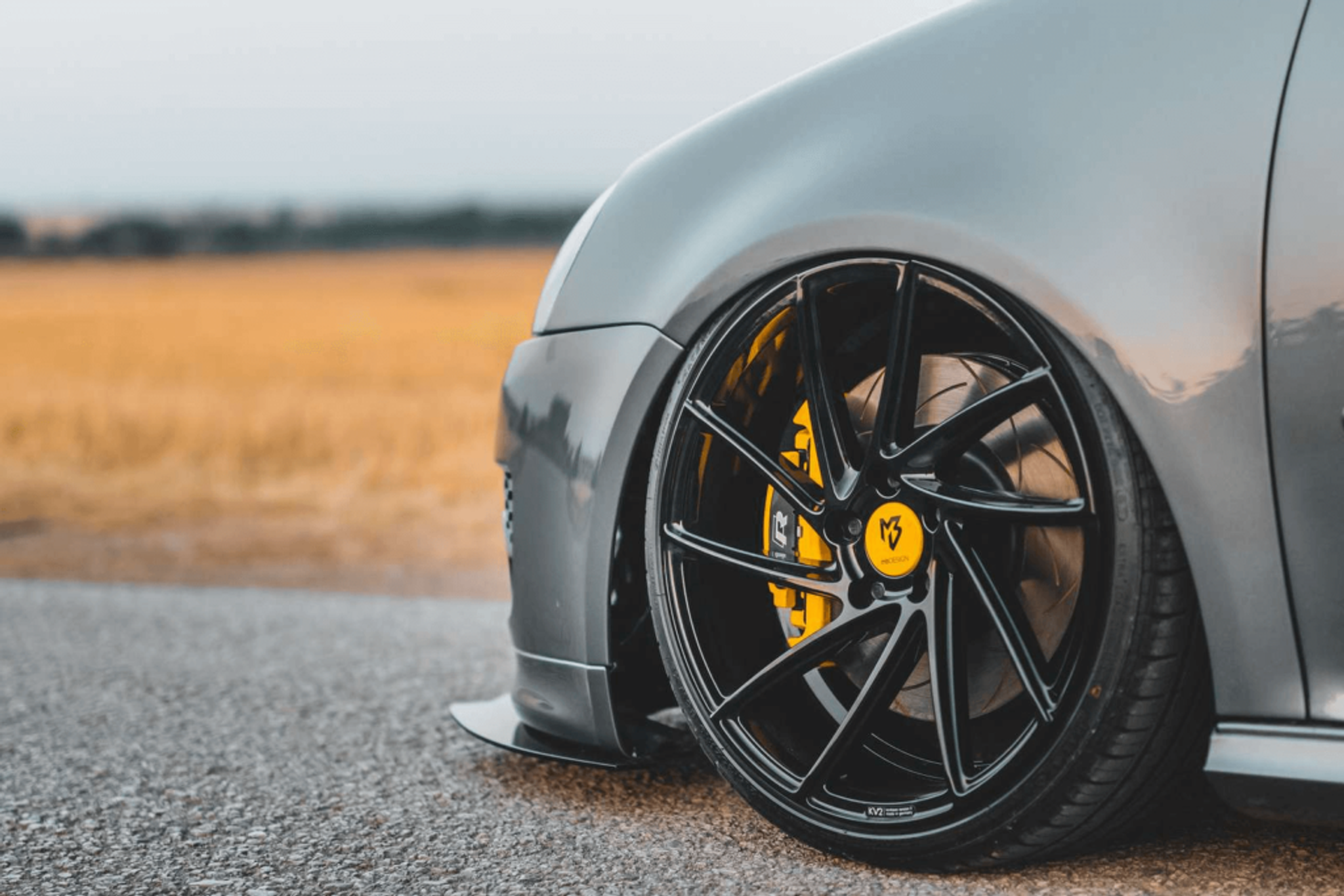 Grey car with yellow brake support
