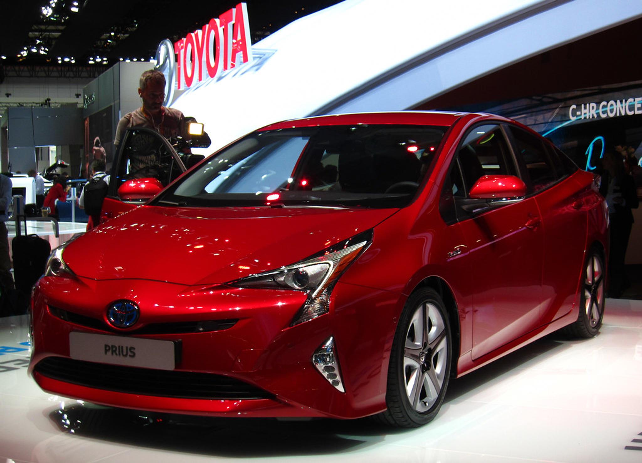 Cherry red Toyota Prius hybrid in a showroom
