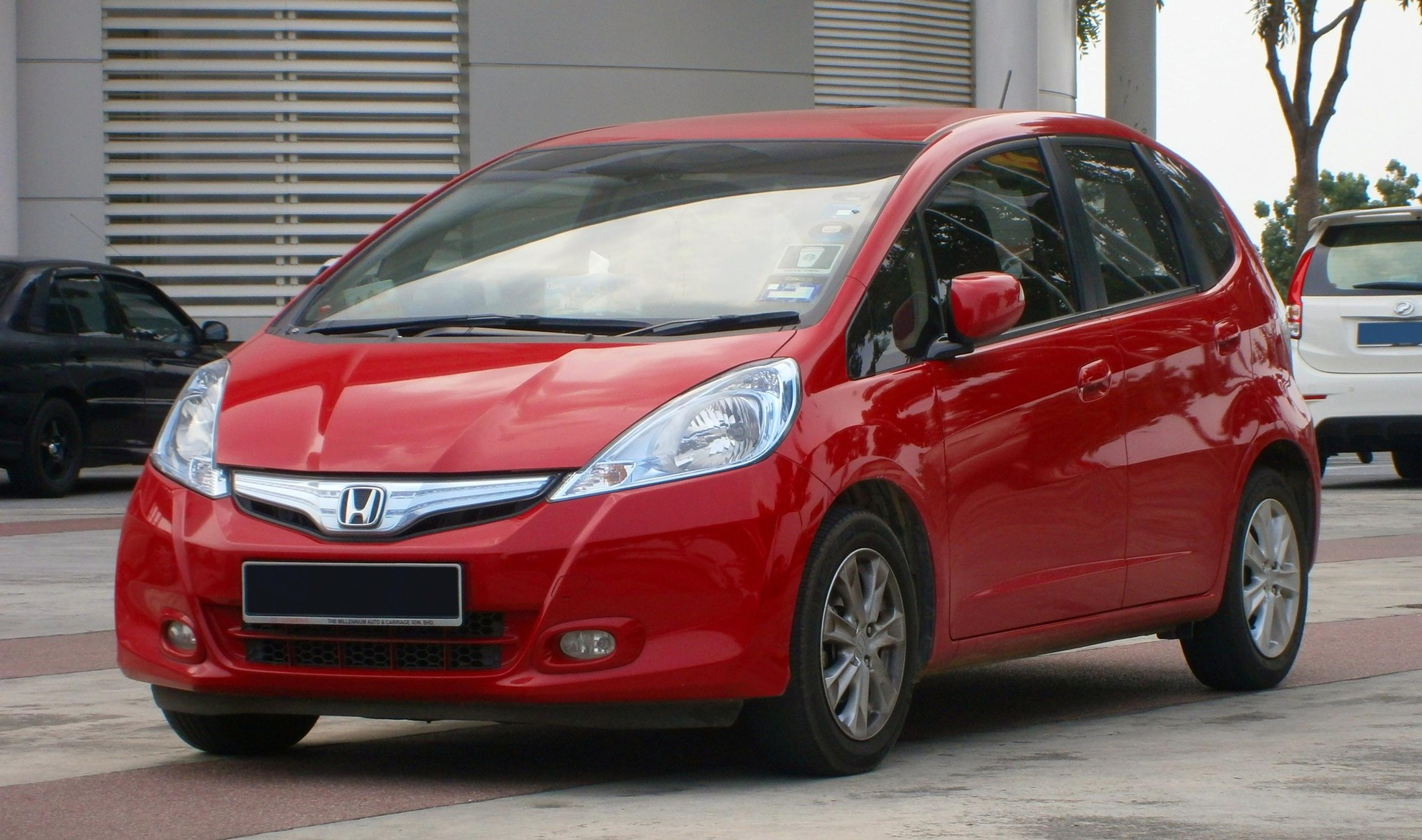 A red Honda Jazz at the dealership