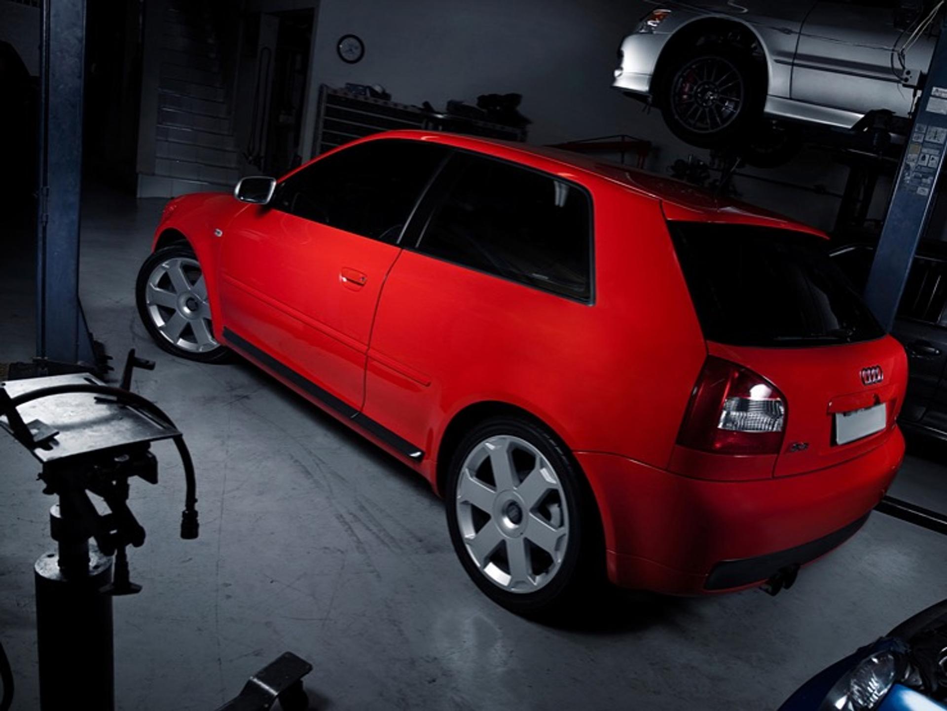 Red Audi A3 parked in a repair shop