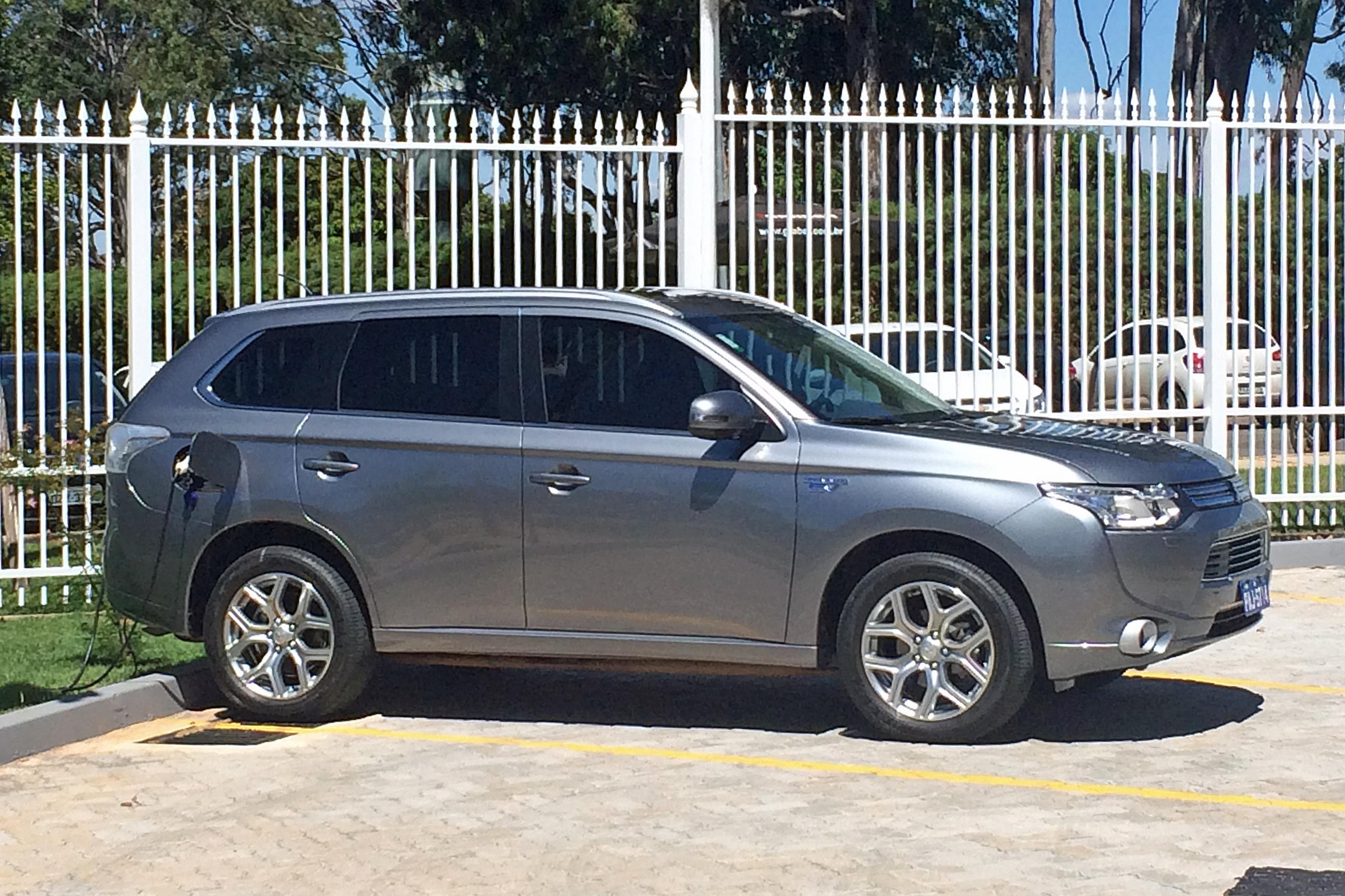A grey Mitsubishi Outlander PHEV charging