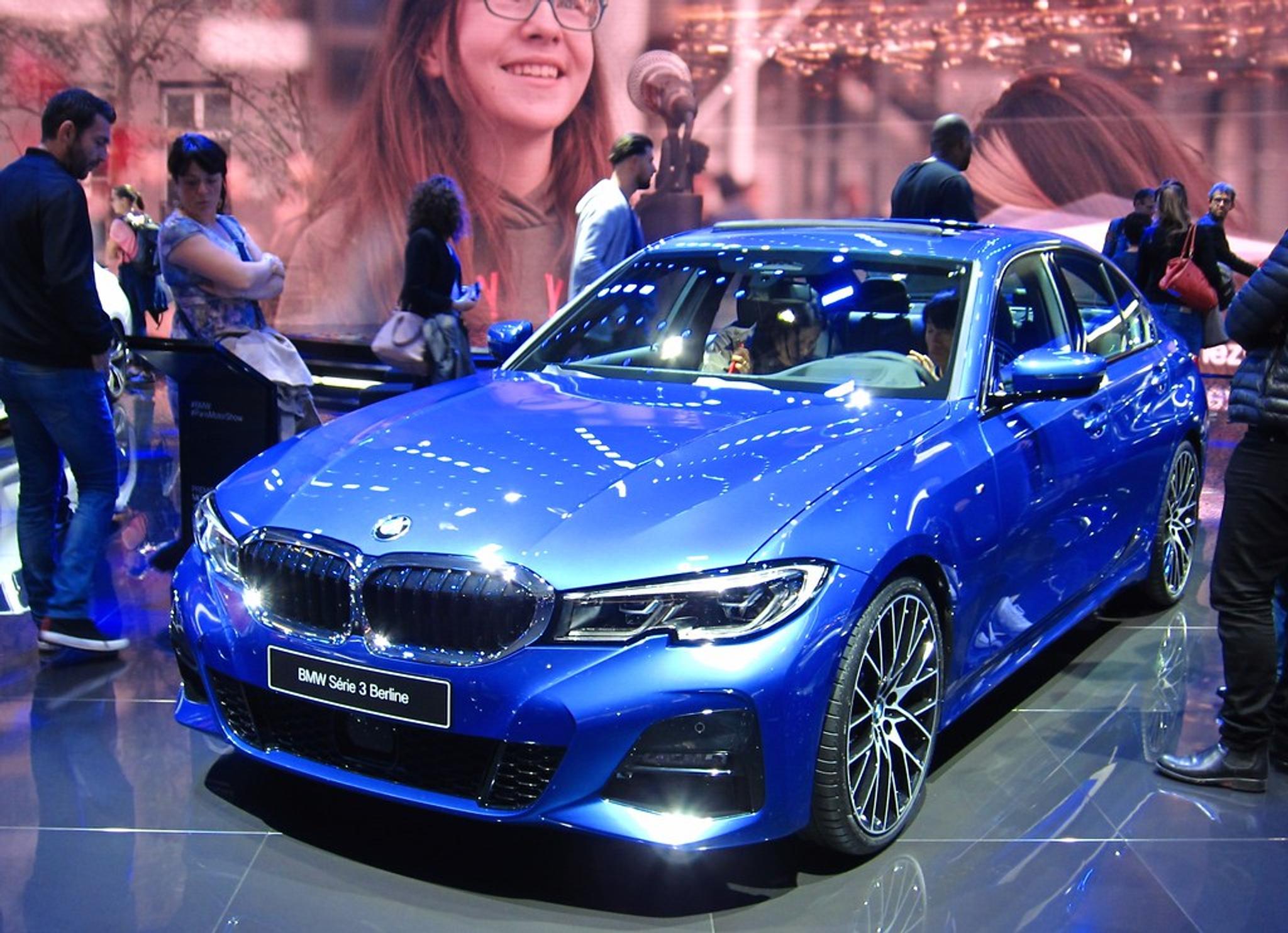 Metallic blue BMW 3 series in a showroom