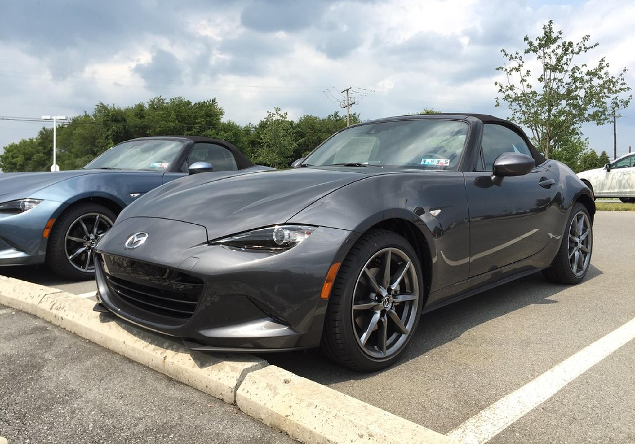 Dark grey Mazda MX-5 Miata in a parking lot