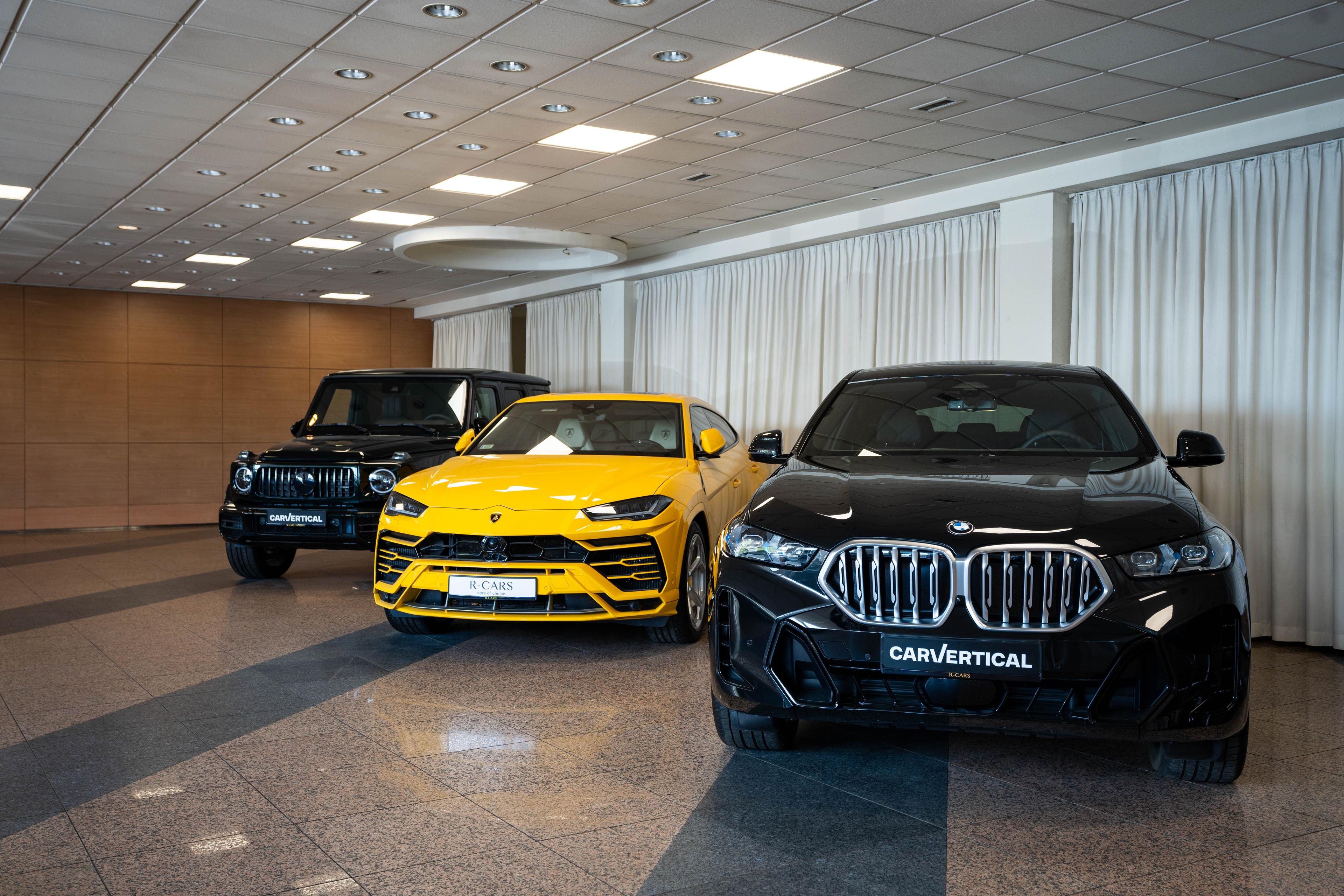 Three cars in a dealership