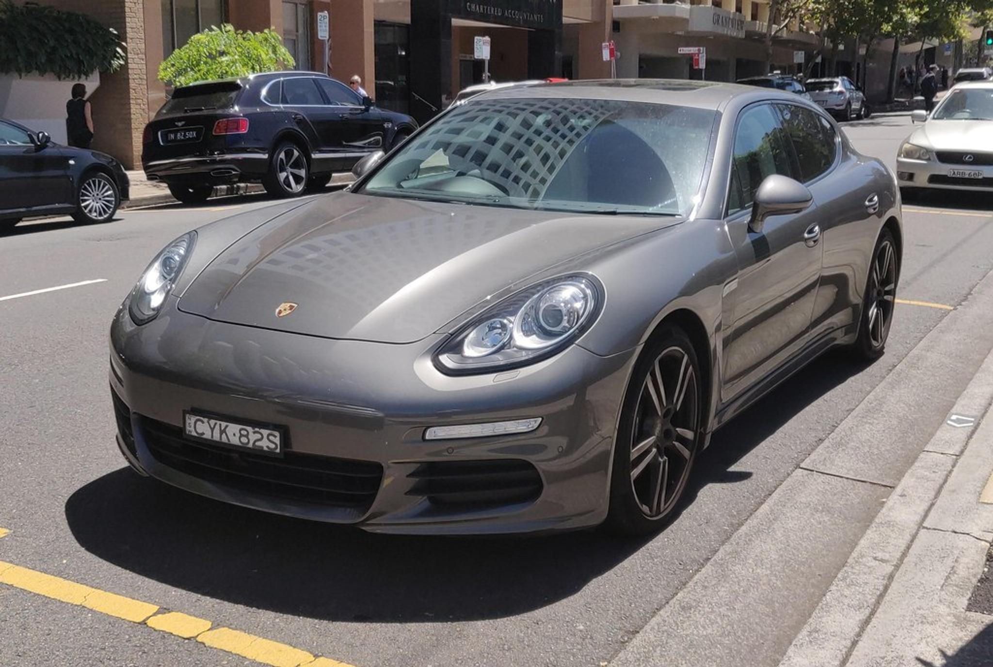 Light brown Porsche Panamera by the side of the road