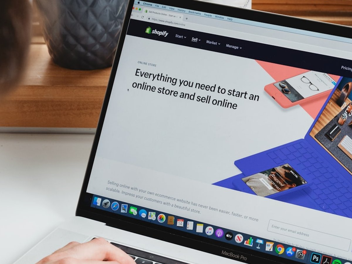Person managing an online storefront on a laptop
