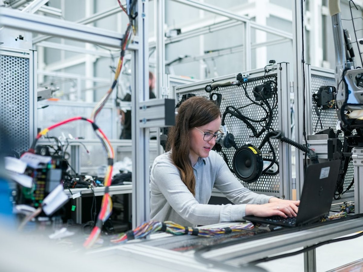 Technician working with equipment on a production line