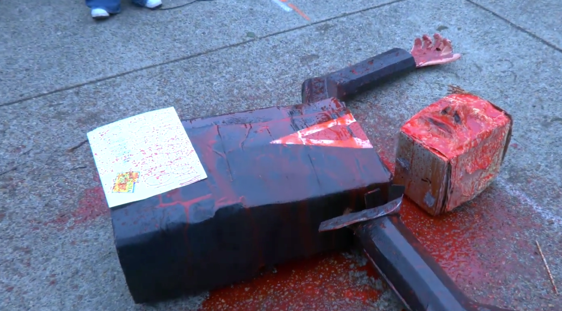 Pro-Palestine mob dumps fake blood on beheaded Trump effigy outside Board of Peace summit in DC