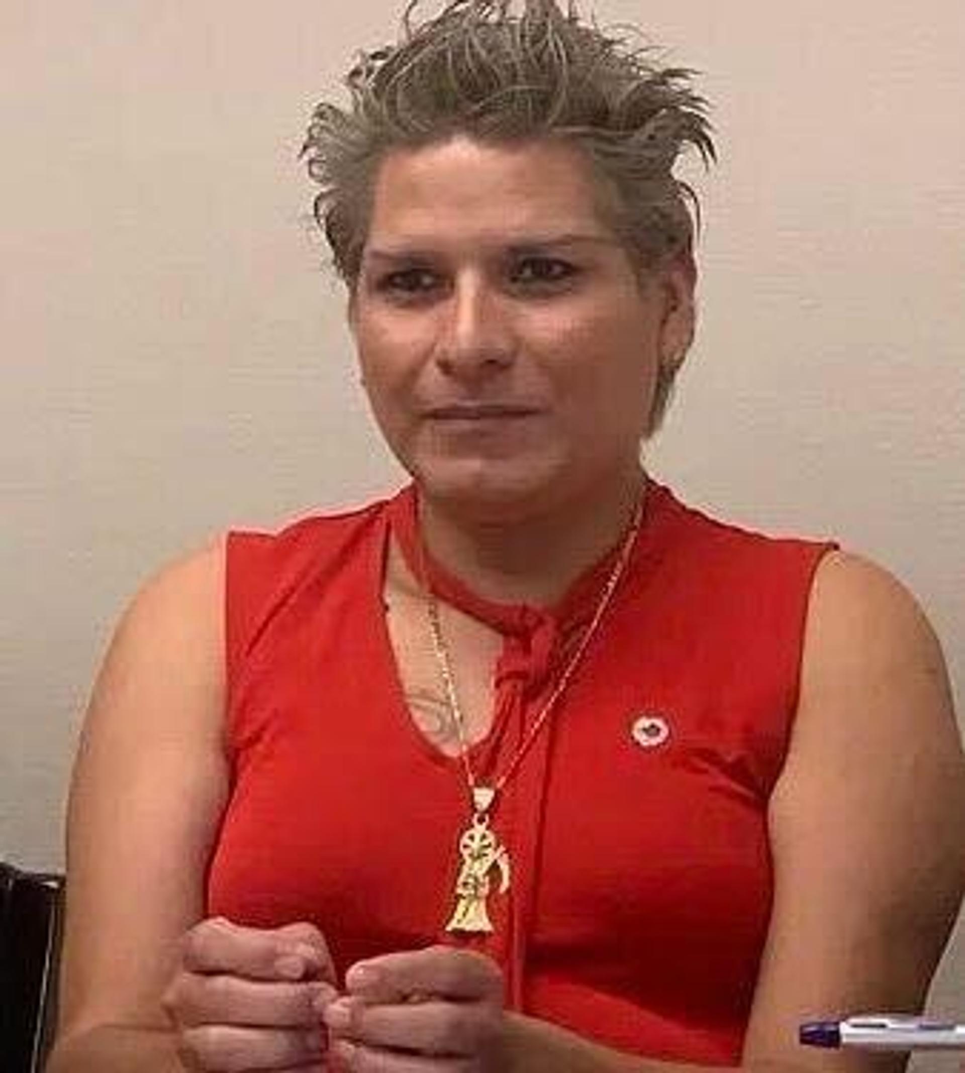 A person in a red dress Description automatically generated with medium confidence