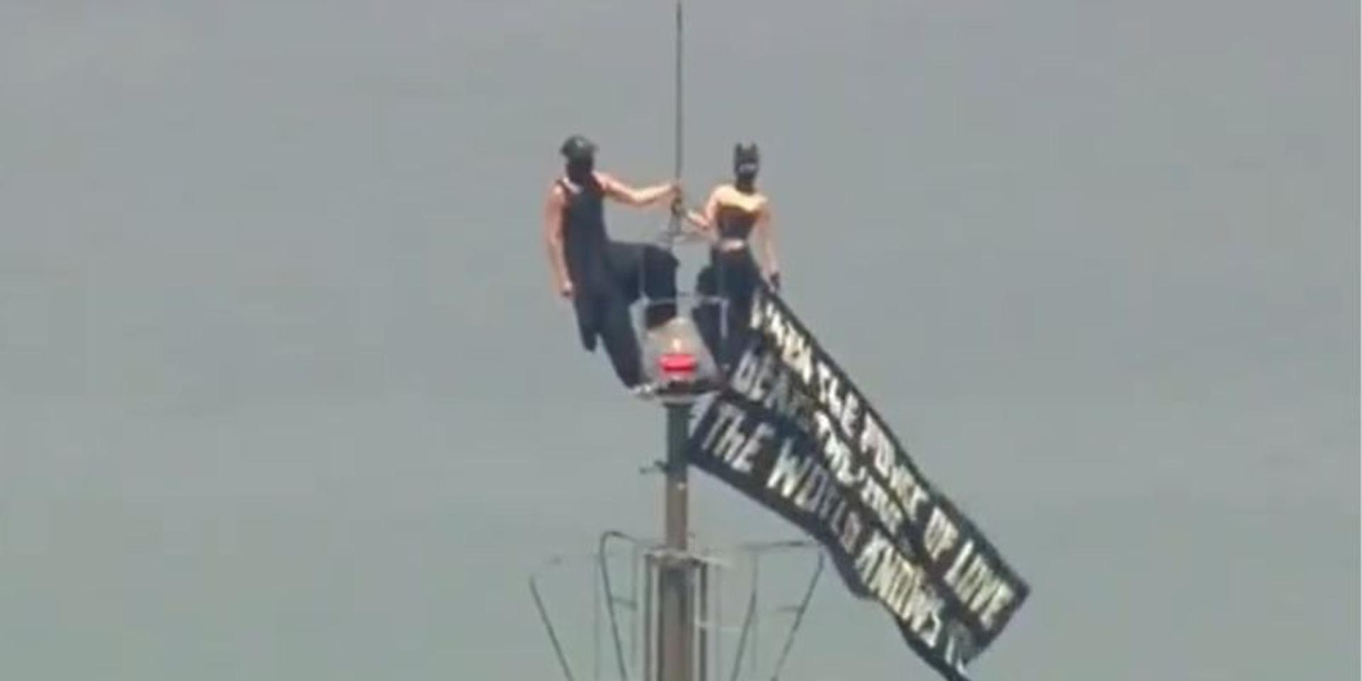 BREAKING: Two masked protestors climb to top of Empire State Building spire