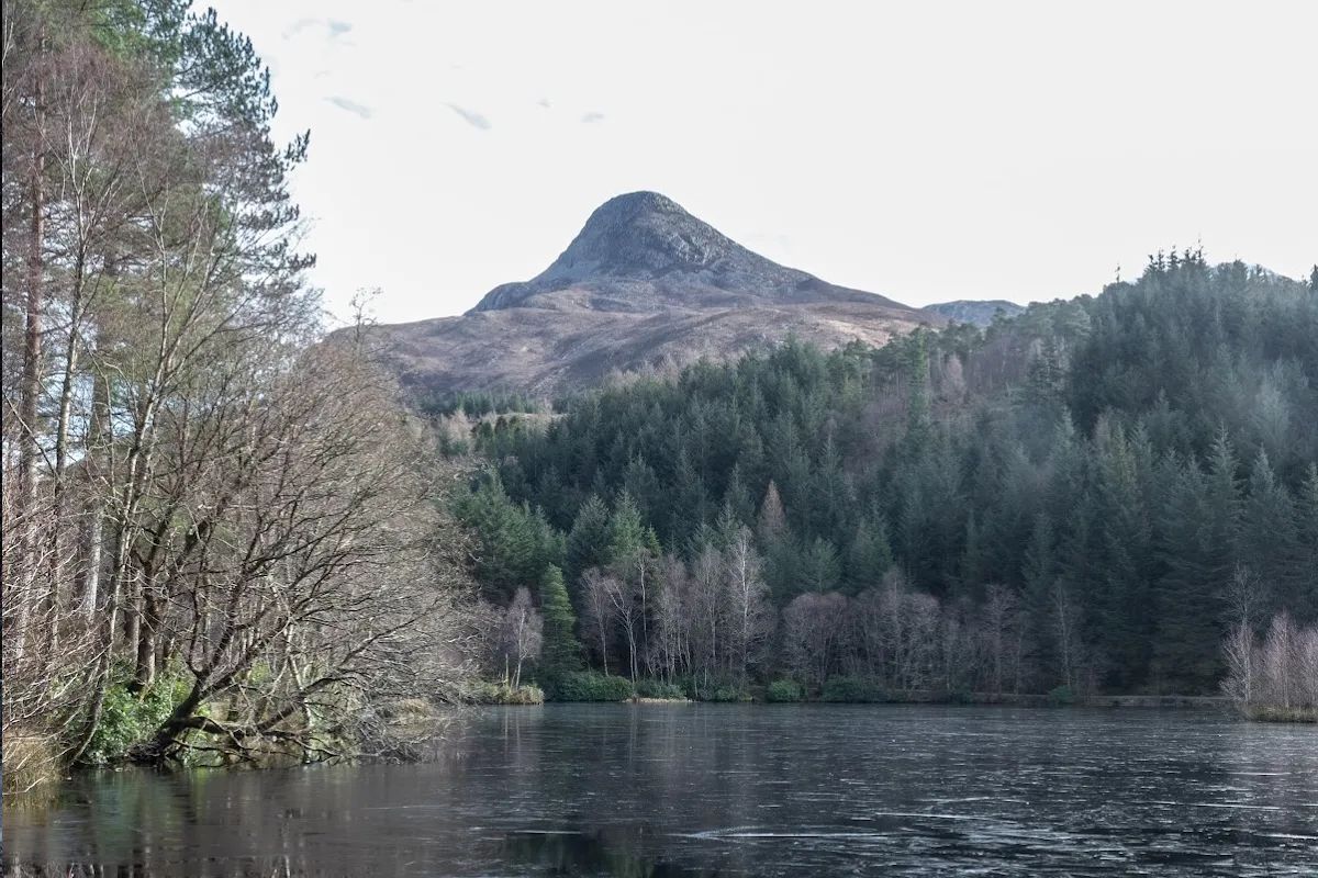 Glencoe Lochan surrounded by colourful trees with mountains reflected in still water — perfect for mirror reflection photography