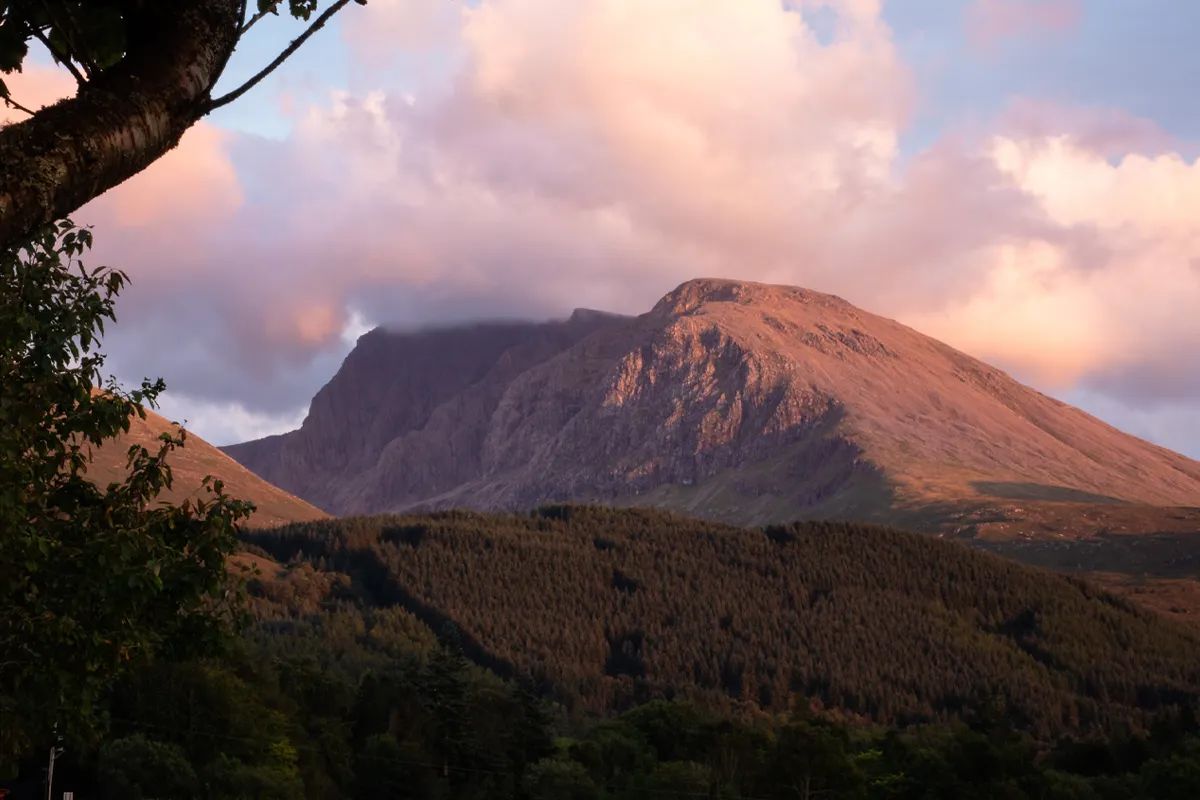 Highwinds Lodge with rainbow and Highland scenery
