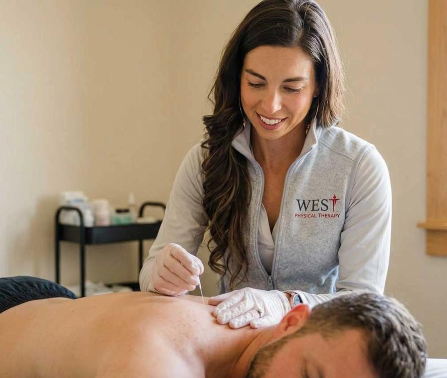 Dr. Mackenzie performing dry needling on a patient's shoulder