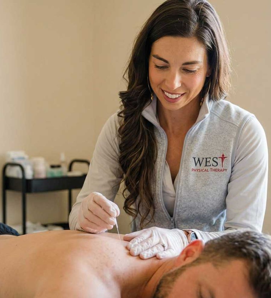Dr. Mackenzie performing dry needling on a patient's shoulder